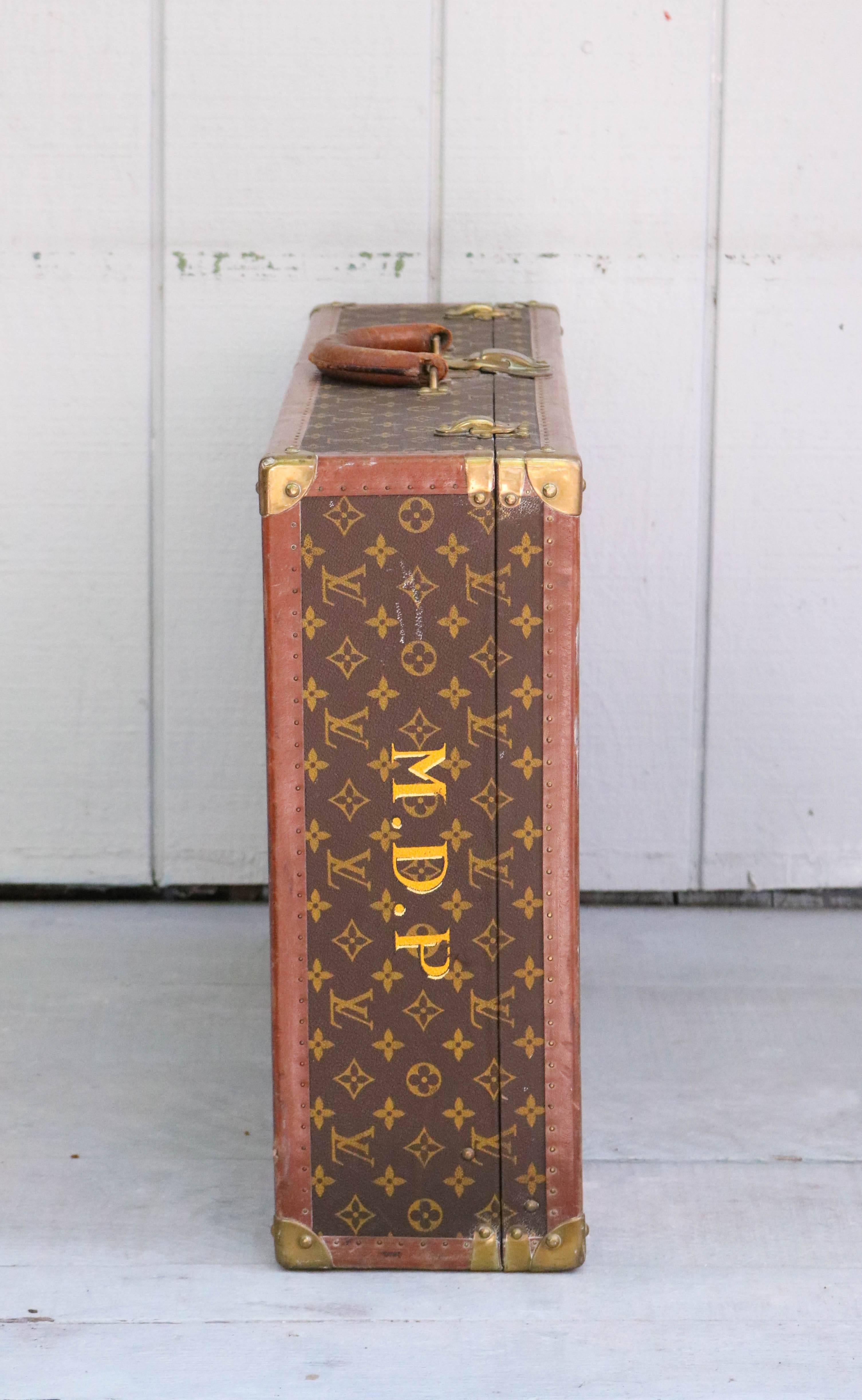 Offered is a vintage Louis Vuitton monogram canvas Bisten 70 Trunk.  Beautifully aged leather and brass shows the history of this item.  Features the historic S-lock invented by Gaston Vuitton to be unpickable. Each lock features a unique number
