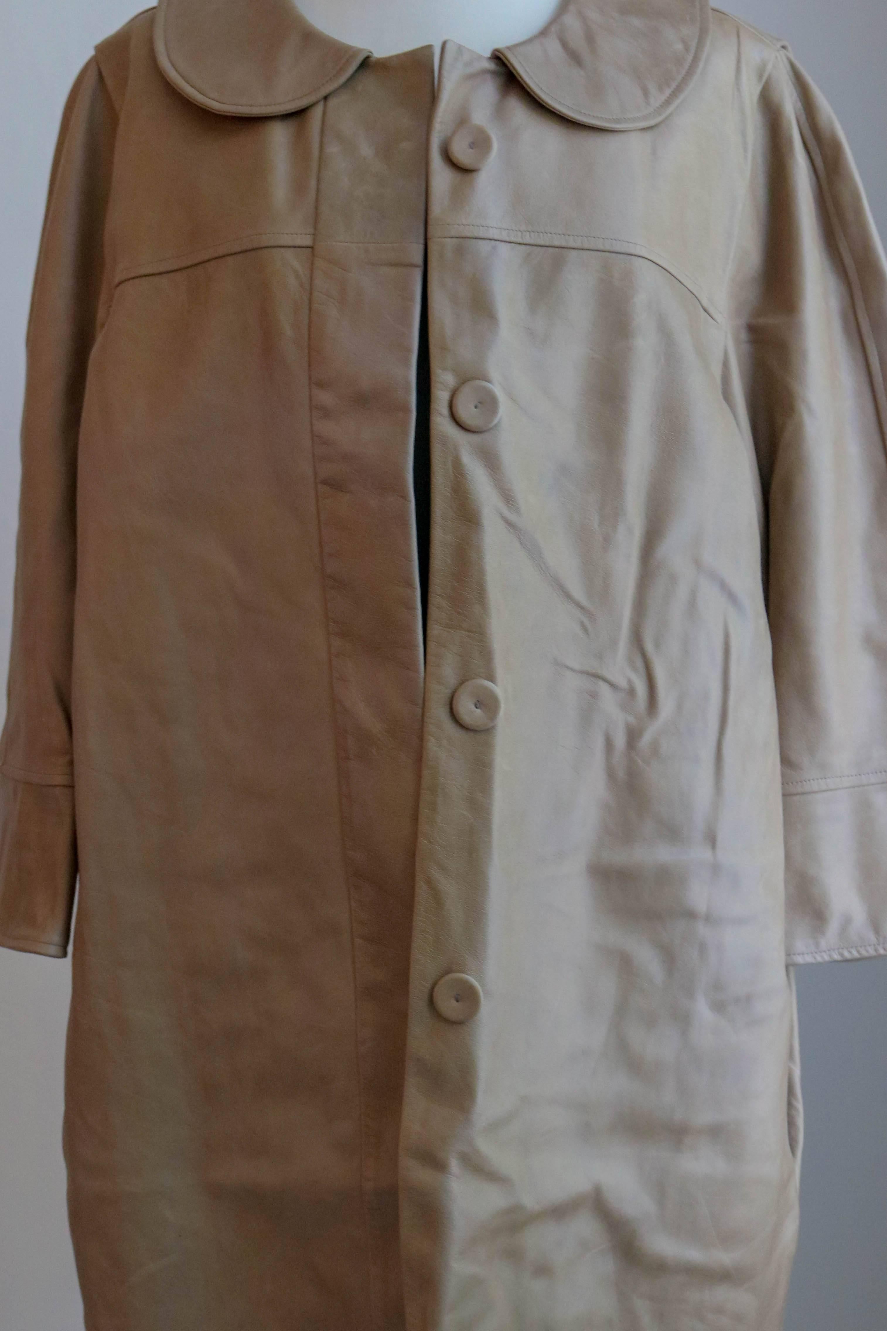 Offered is a one of a kind tan 100% lambskin leather coat by Chloe. Made in Paris, the details of construction are impeccable.  3/4 length sleeves , covered buttons ,  and just below knee length.   Condition is very good, pre-owned item is estimated