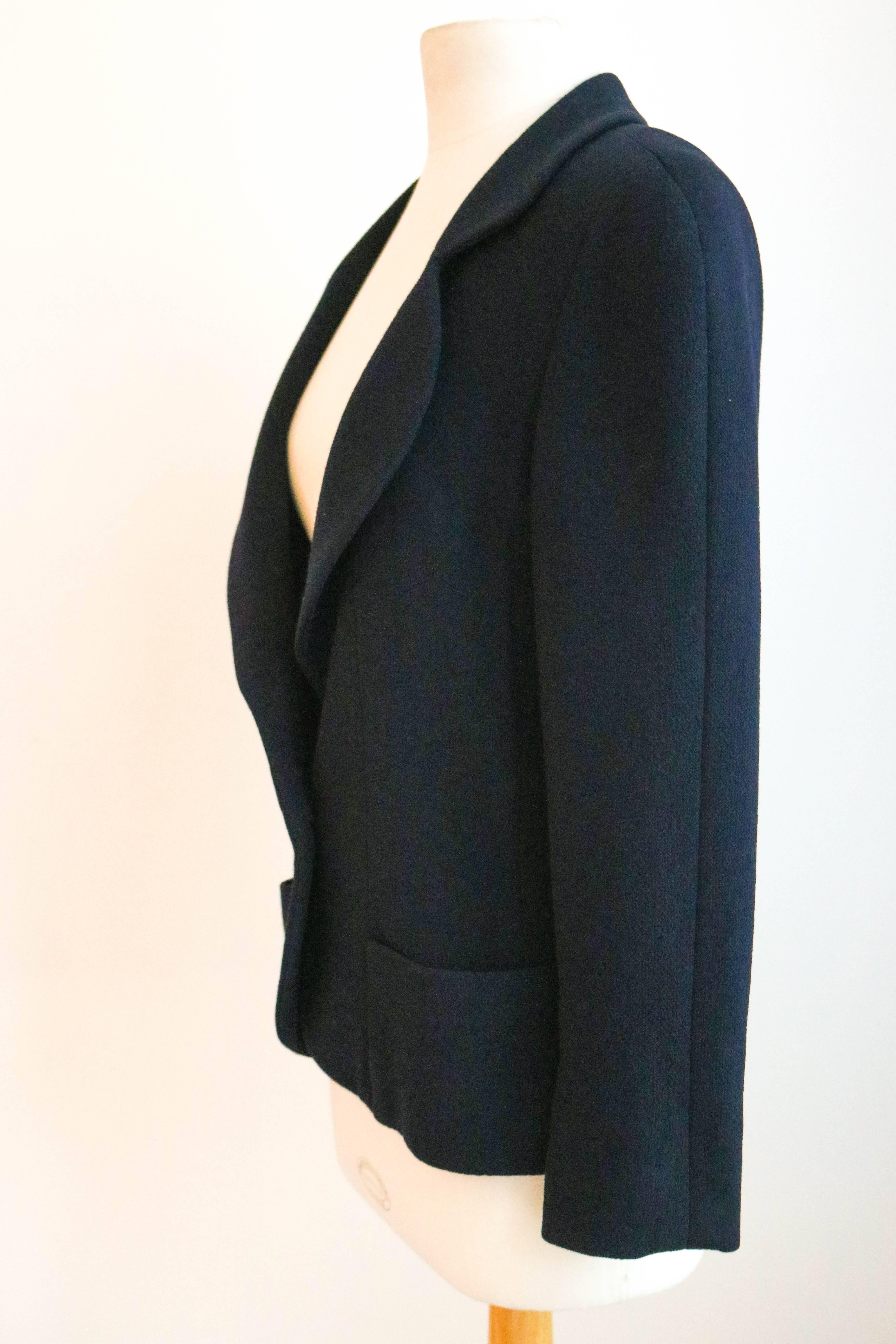 Offered is a classic Chanel blazer in navy with elegant details.  Fitted waste with a notched collar.  One large round button with gold CC logo. Two pockets on front.  Fitted to size on model to be 36, tags have been removed.  
