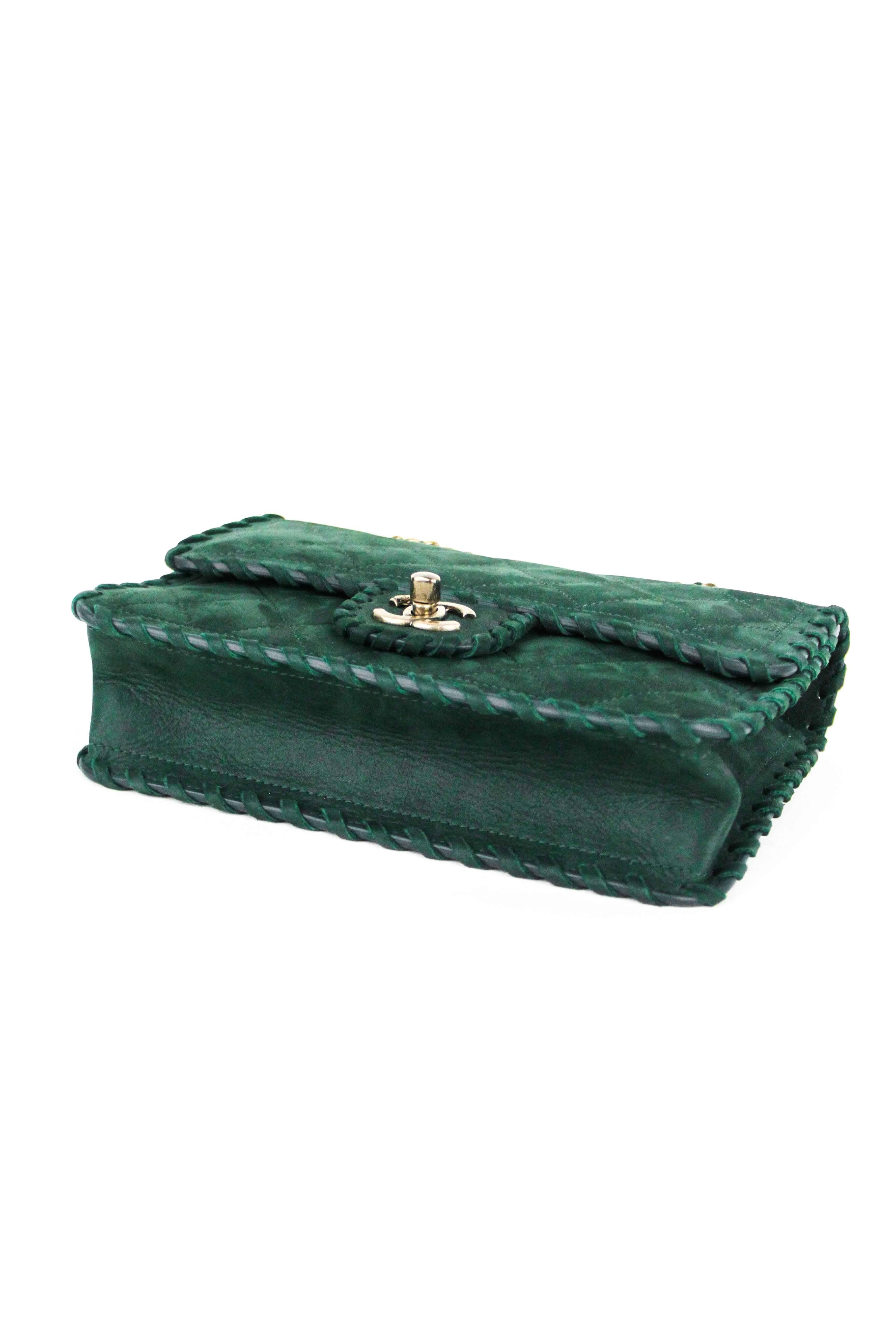 Offered is a new pre-owned item from Chanel, a striking kelly green suede flap with gold-tone hardware. Classic chain handle with beautiful details.  Whip stitch  monochrome trim on green quilted suede making this the ideal bag for fall.  Comes with