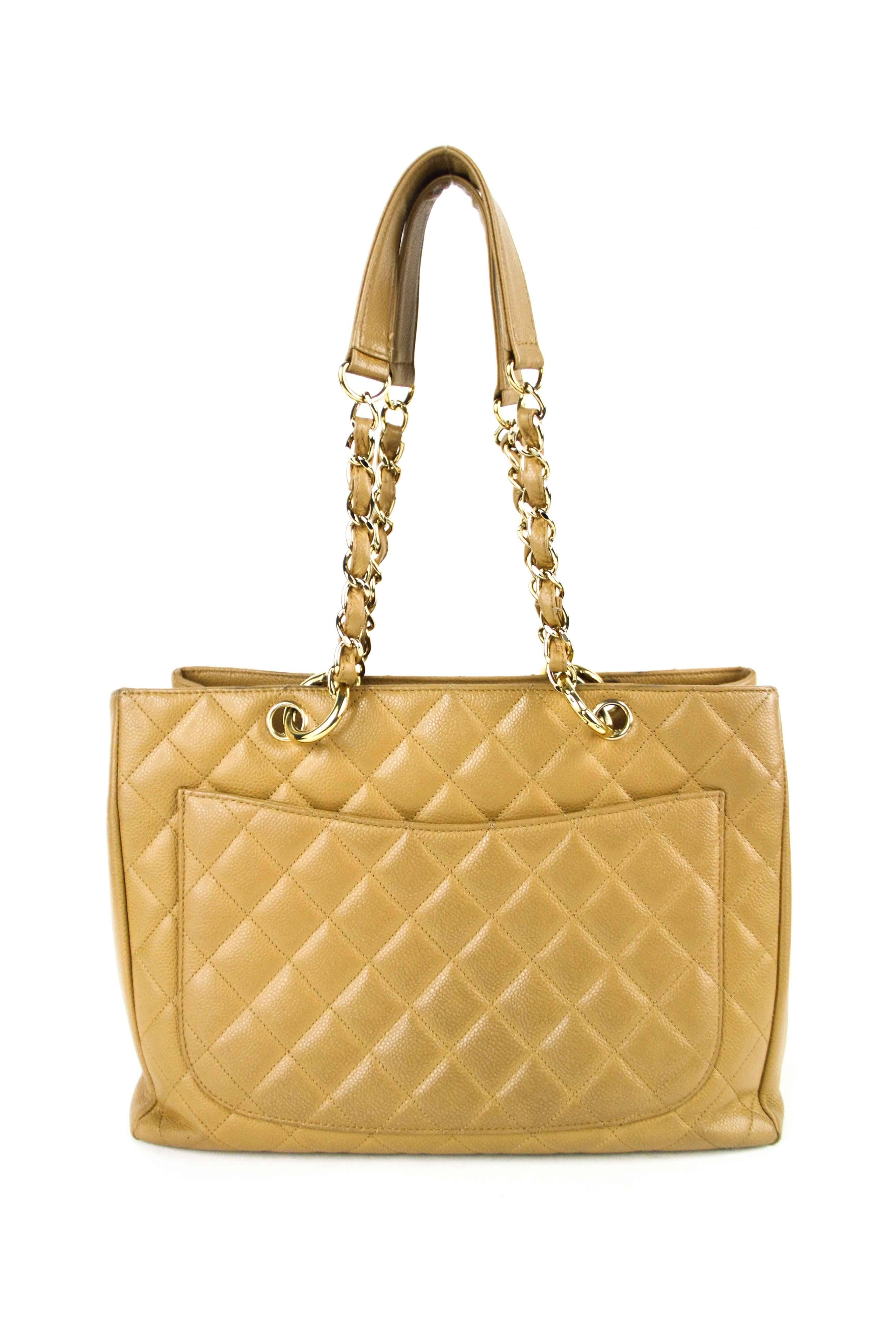Authentic Chanel Caviar Quilted Grand Shopping Tote GST in Beige, Features large signature quilted Chanel CC logo on the front, wide flat pocket on the back. Classy beige leather threaded with gold chains straps with leather shoulder pads. Open top
