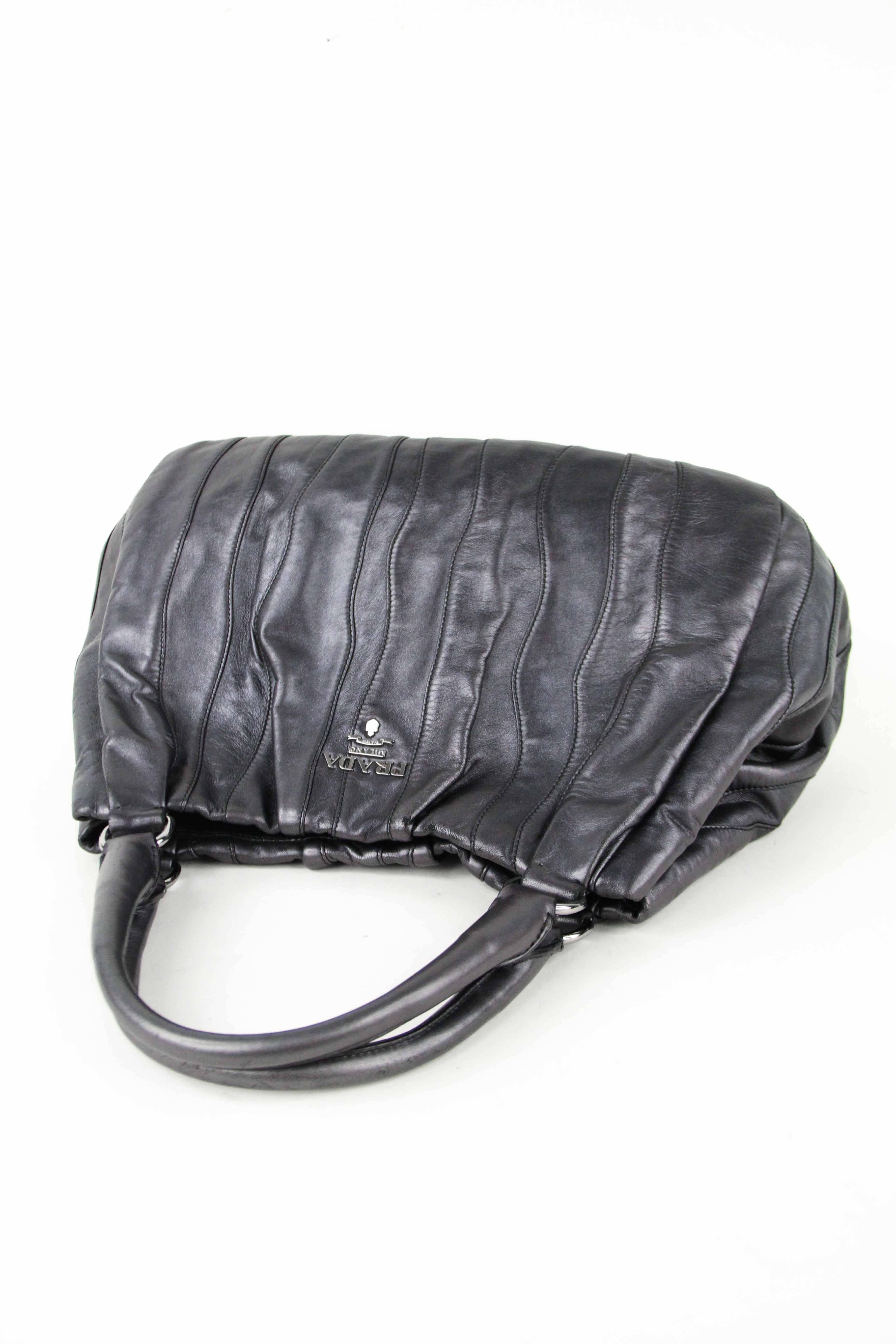 Offered is a beautiful pewter metallic hobo bag with striped stitching details throughout.  Amazing craftsmanship and design on a supple Napa calfskin.  Two rolled leather handles with a large strap drop for easy wearing on shoulder. 
Grey gunmetal