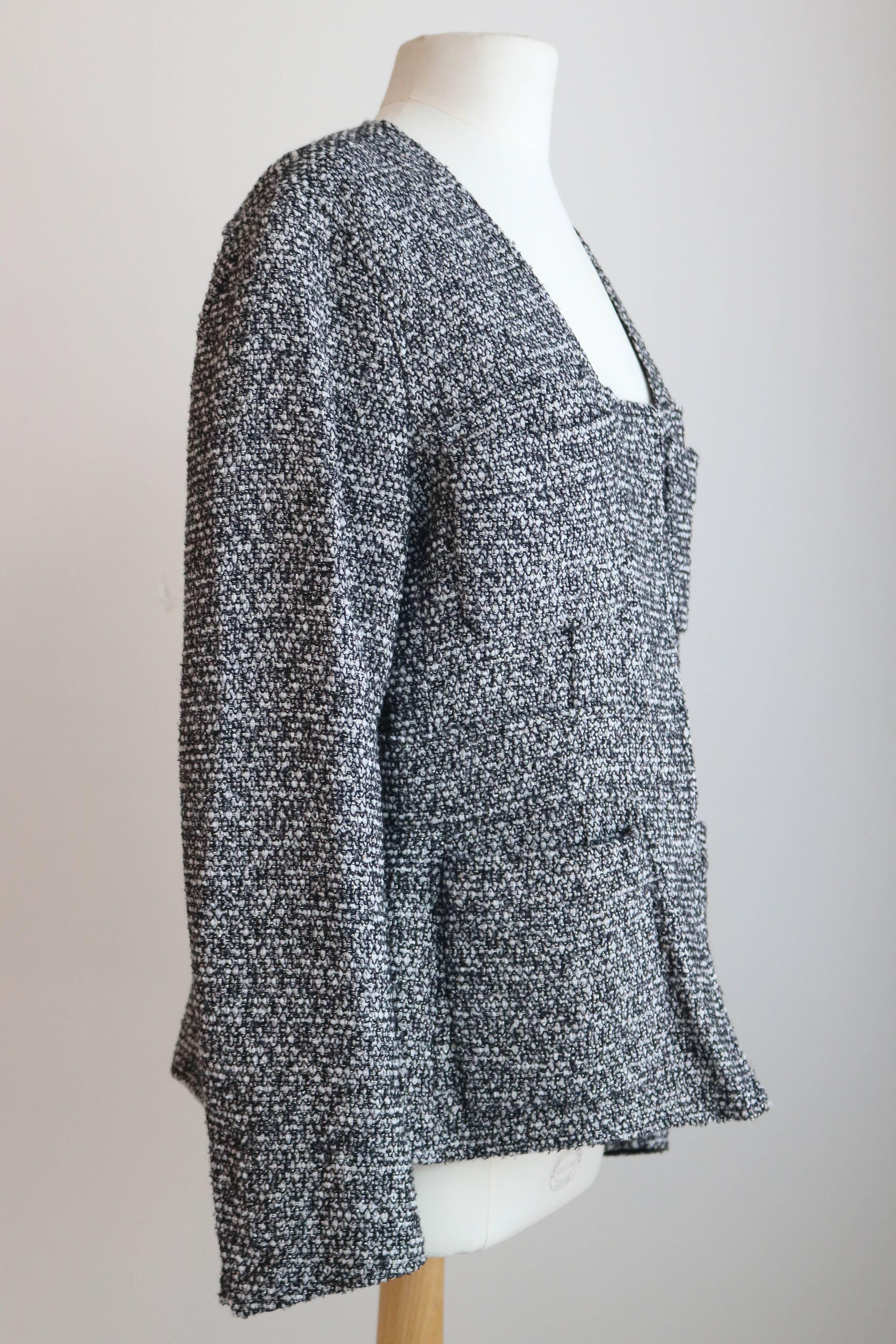 Offered is a great looking piece by YSL, a black and white tweed jacket with silver thread embellishment throughout. Beautiful details, stitched inset belt design to enhance waist, four pockets, and hidden zipper.  Made in France.  Condition is very