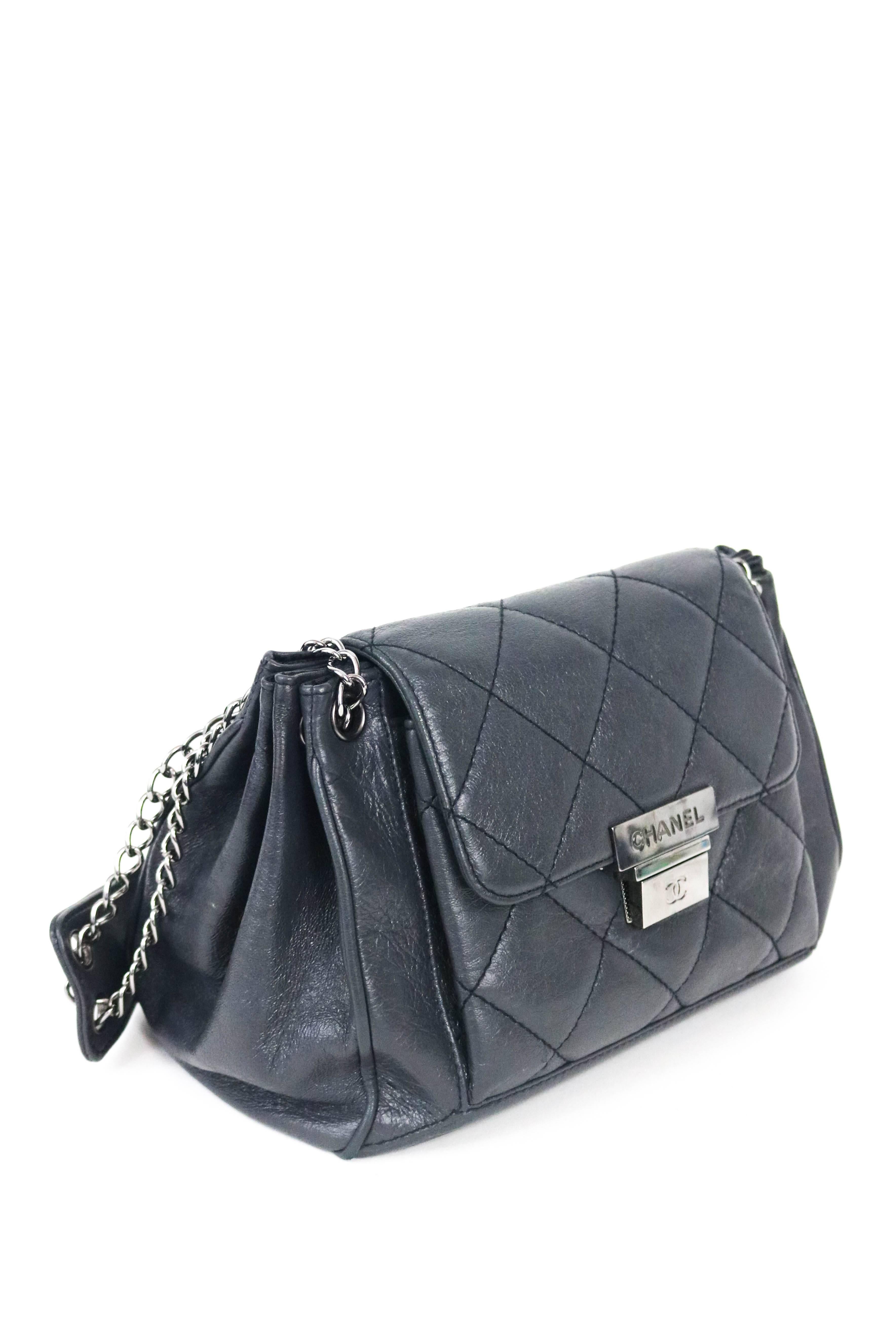 Offered is an authentic and darling handbag from Chanel, in a metallic pewter color a small quilted double chain shoulder bag.  Gunmetal hardware perfectly compliments the color of the supple calfskin. Chanel logo is embossed into lock on front. 