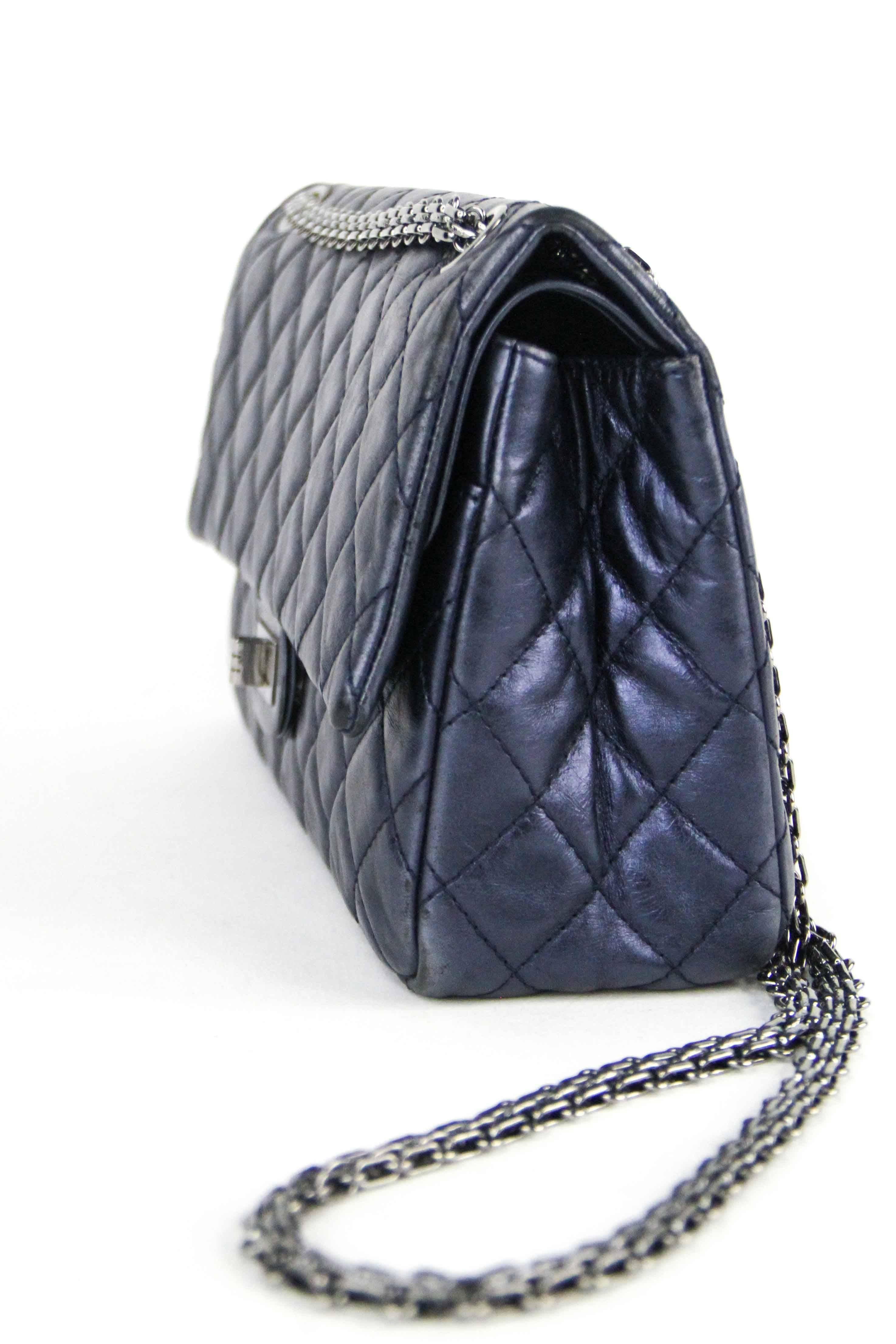 Offered is am authentic navy quilted 226 Reissue double flap handbag from Chanel. Navy calfskin with silver hardware.  Mademoiselle lock on front with reissue chain. Very good condition , wear minimal for an item this age.  (2009 ) 

DIMENSIONS: