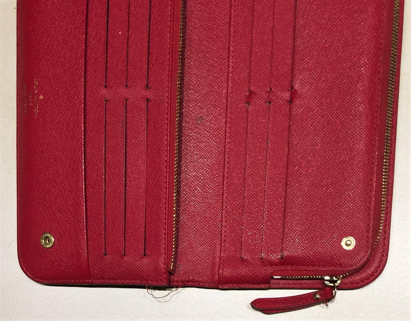 Louis Vuitton Wallet. Portefeuille Insolite for change and notes.  Natural Cowhide Leather; Red Leather Interior.  LV Monogram.  Button/Snap Fastener Opening.  12 Credit/debit Card Slots; 2 Zipped Coin Pouches; Serial /Model No M6042.  Size 21cm by