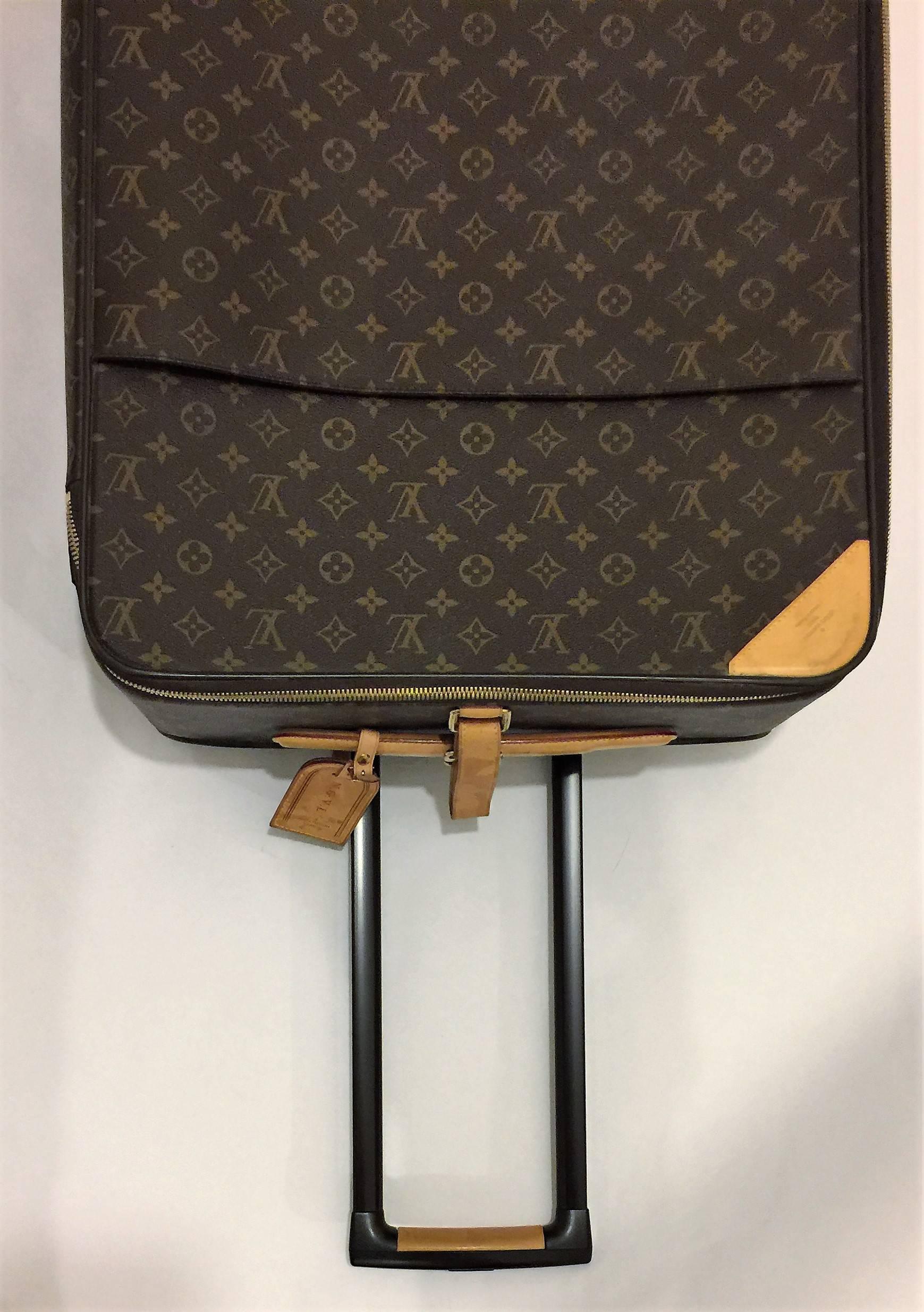 Black Louis Vuitton Pegase 65 monogram rolling suitcase.