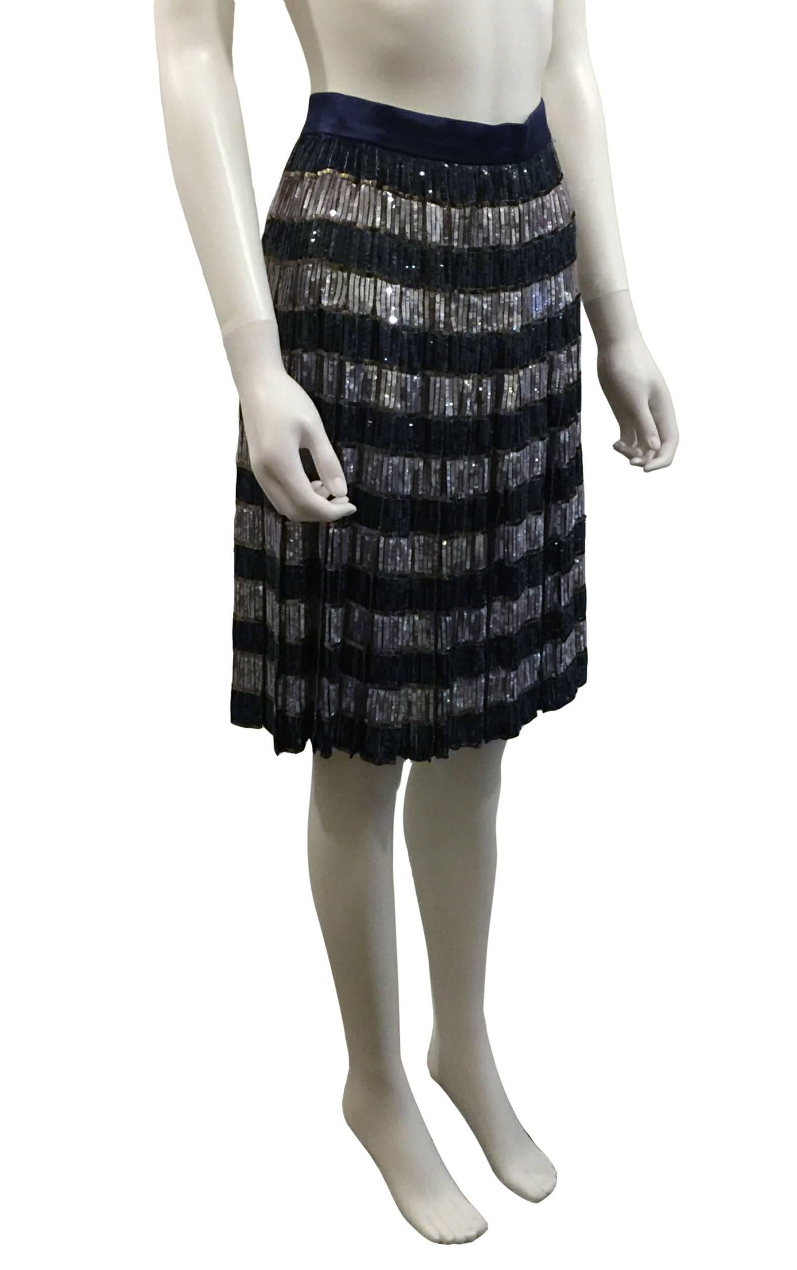Valentino Sequin Skirt.  Vintage.   Size UK10.  Pleated knee-length sequin skirt in shades of blue/mauve & black.   Good condition.  This item is guaranteed to be 100% authentic.  Purchased from the Valentino 1990’s Collection.   This item is a
