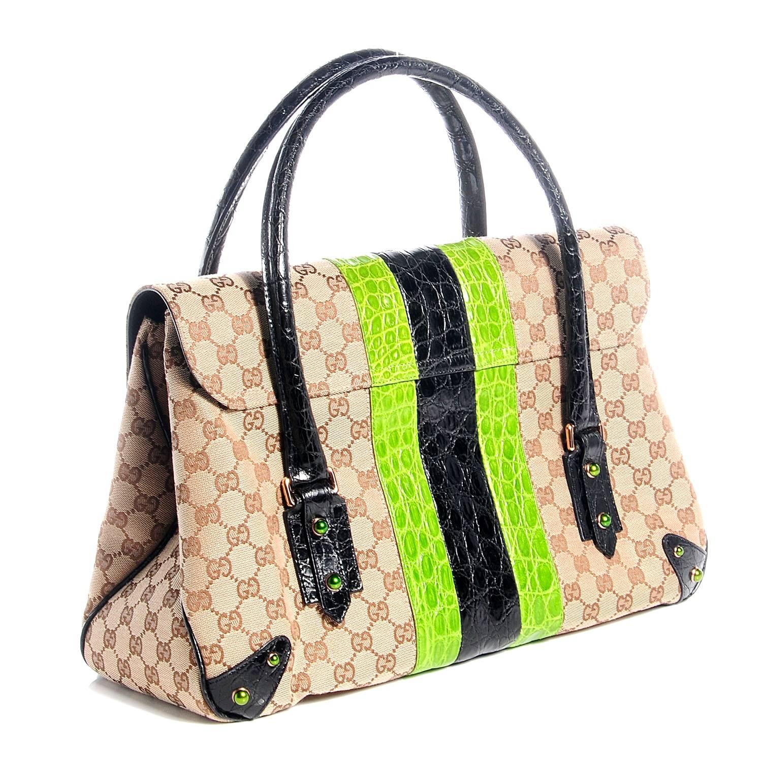 STUNNING TOM FORD CLASSIC

This gorgeous piece is crafted of brown Gucci GG monogram canvas with remarkable crocodile features - a wide central stripe of neon green and black crocodile skin, black crocodile top handles and corner plates.
The