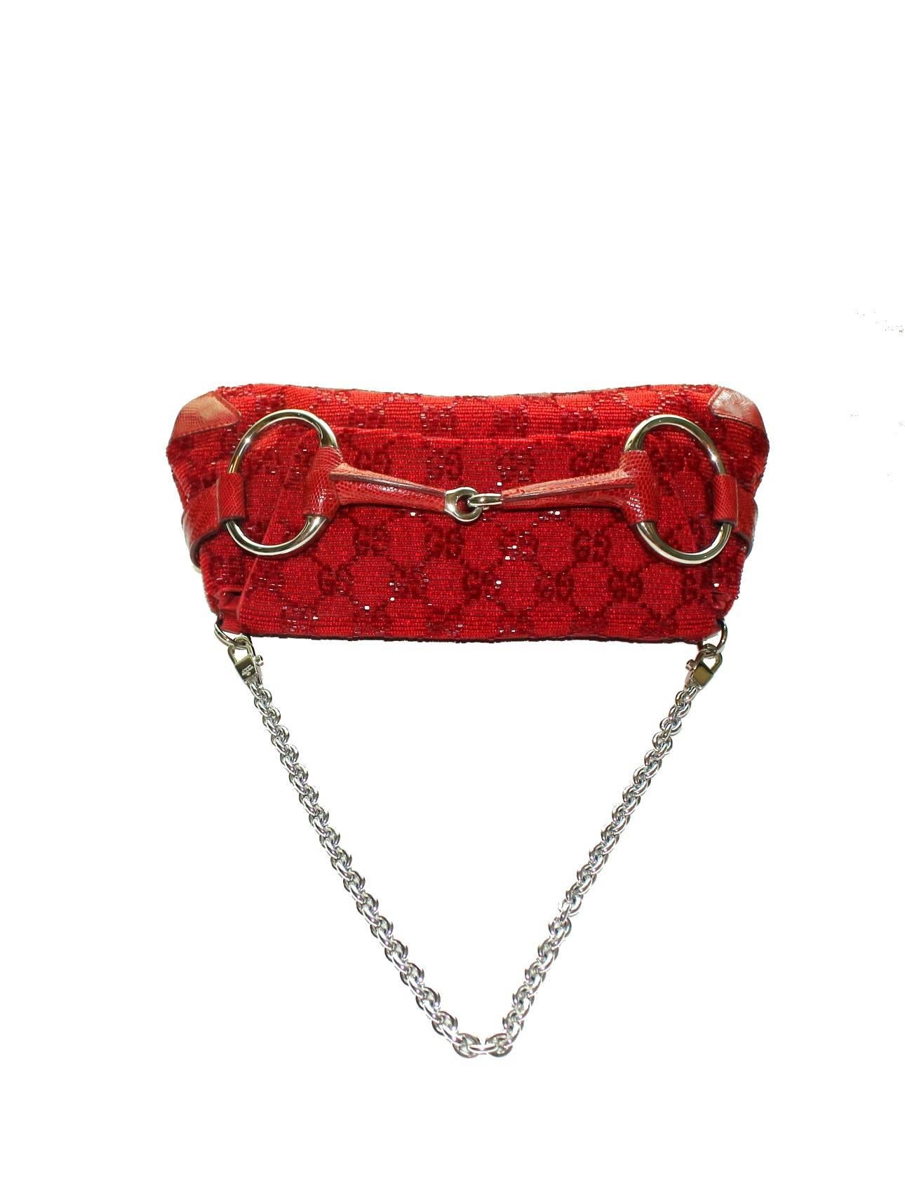 A Gucci signature piece in the famous GG Monogram

Beautiful beaded red bag with lizard skin trimmings
Famous Gucci signature horsebit design
White-gold colored hardware
Detachable strap discreedly engraved with 