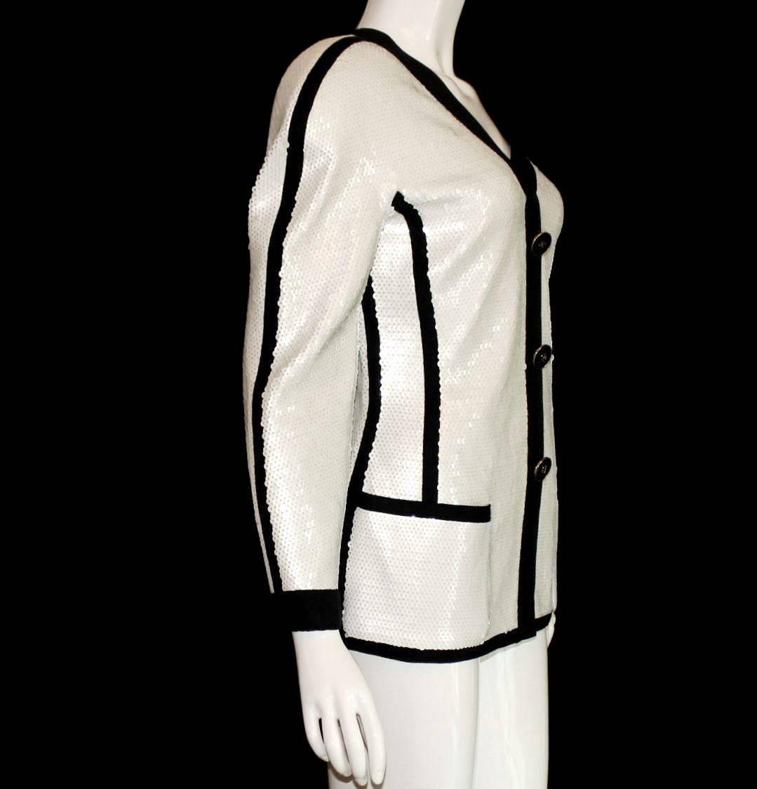 An extremely rare Chanel jacket from the early 1990s
Seen on Vogue Editor Anna Wintour
Part of the Exhibition in the Metropolitan Museum in NY in 2005
White Sequin Jacket with black trimming
Closes with a hidden zip in front
Decorative black CC logo