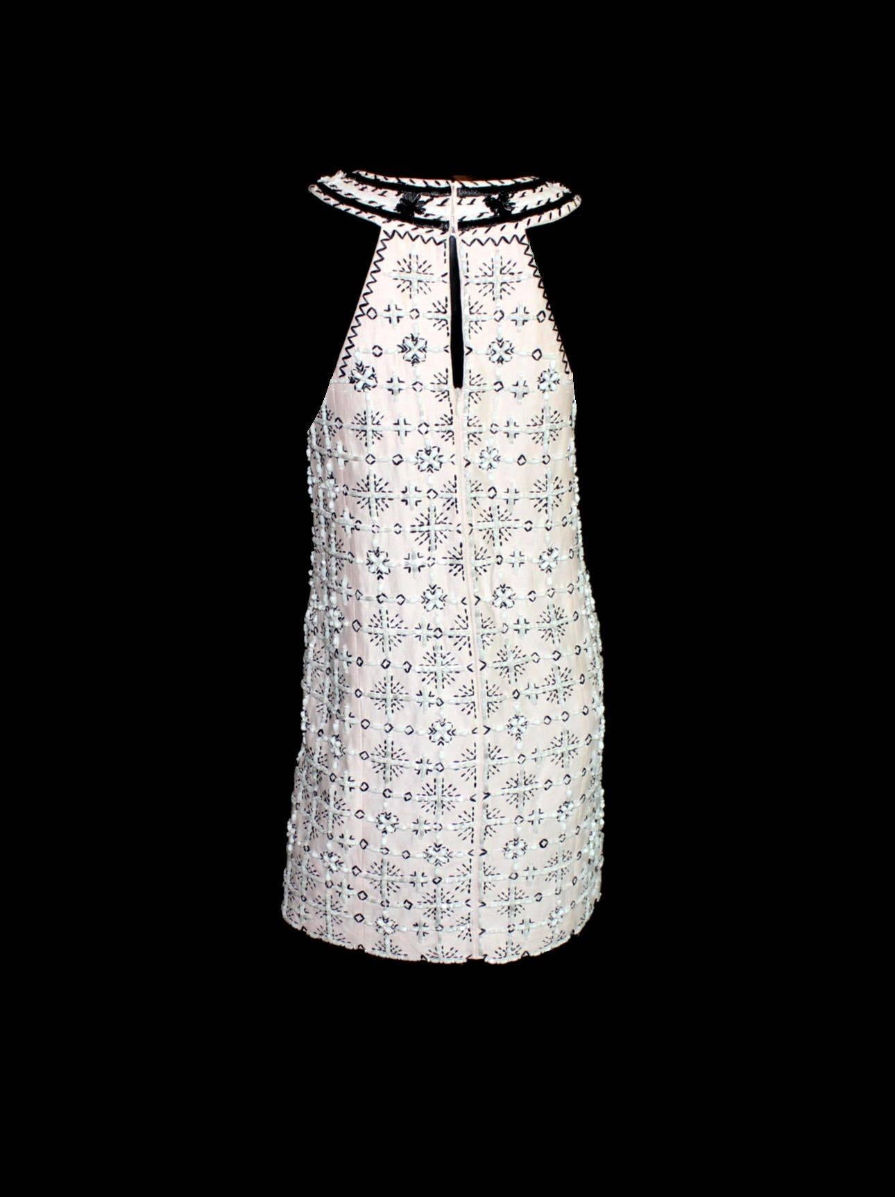 Stunning cocktail dress by Emilio Pucci
Blush linen silk fabric with black and white trimming
Full beading
Beautiful embroidery and flower trimming
Fully lined
Closes with zip in back
Made in Italy
Size 40
New, unworn

Please refer to the celebrity