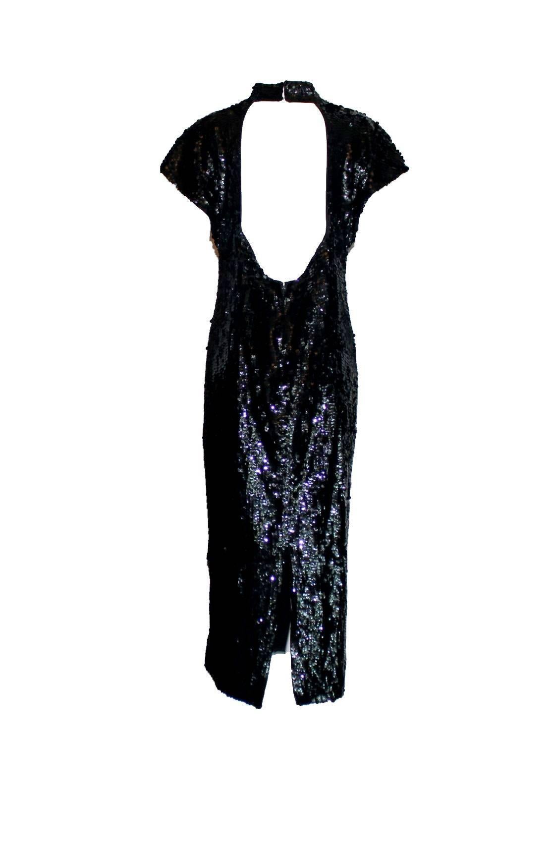 Black Chanel Boutique sequin dress
A timeless Chanel classic
Loose fit
Features a banded collar
Cut-out back
Short sleeves
Long slit in back
From late 1980s - early 1990s
Chanel faux pearl necklace not included



