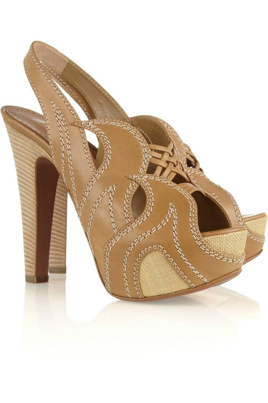      An AZZEDINE ALAIA classic signature piece that will last you for years
    This gorgeous pair of heels are made out of raffia and tan leather with cut-out details
    Wooden heel
    Simply slip on
    Contrast cream stitching
    Peep toe