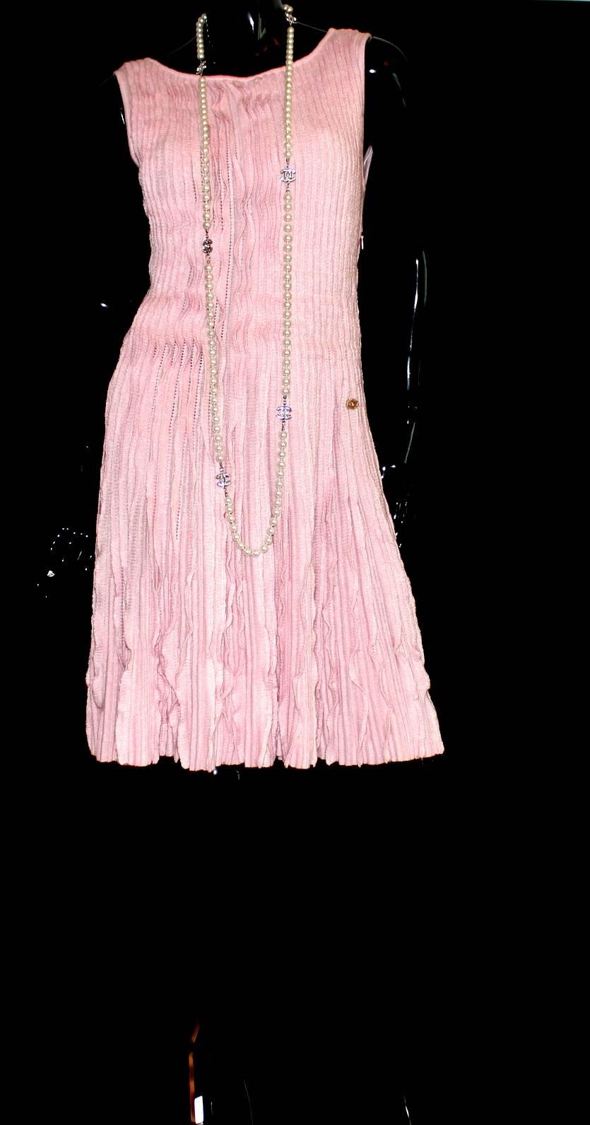 A beautiful Chanel dress 
Candy pink color with a ruffle body, zip up side, the piece is very constructed around the waist so it really holds you in
Chanel CC logo button sewn in by the waist
A timeless Chanel piece for every season
Brandnew and