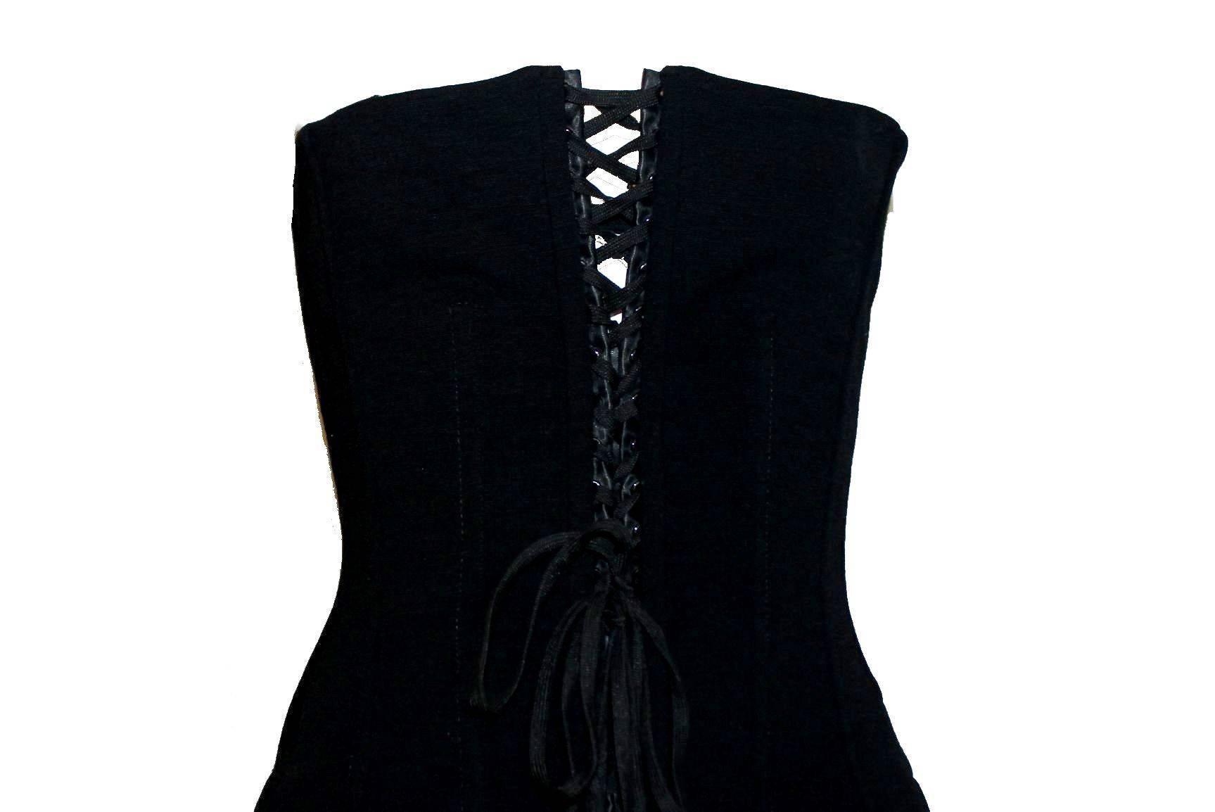 Timeless black dress by Dolce & Gabbana
Stunning corset part with lace up detail in front
Corset fully boned for a perfect fit
Two side pockets
Closes with zip in back
Lined with black silk
Made in Italy
Dry Clean Only
