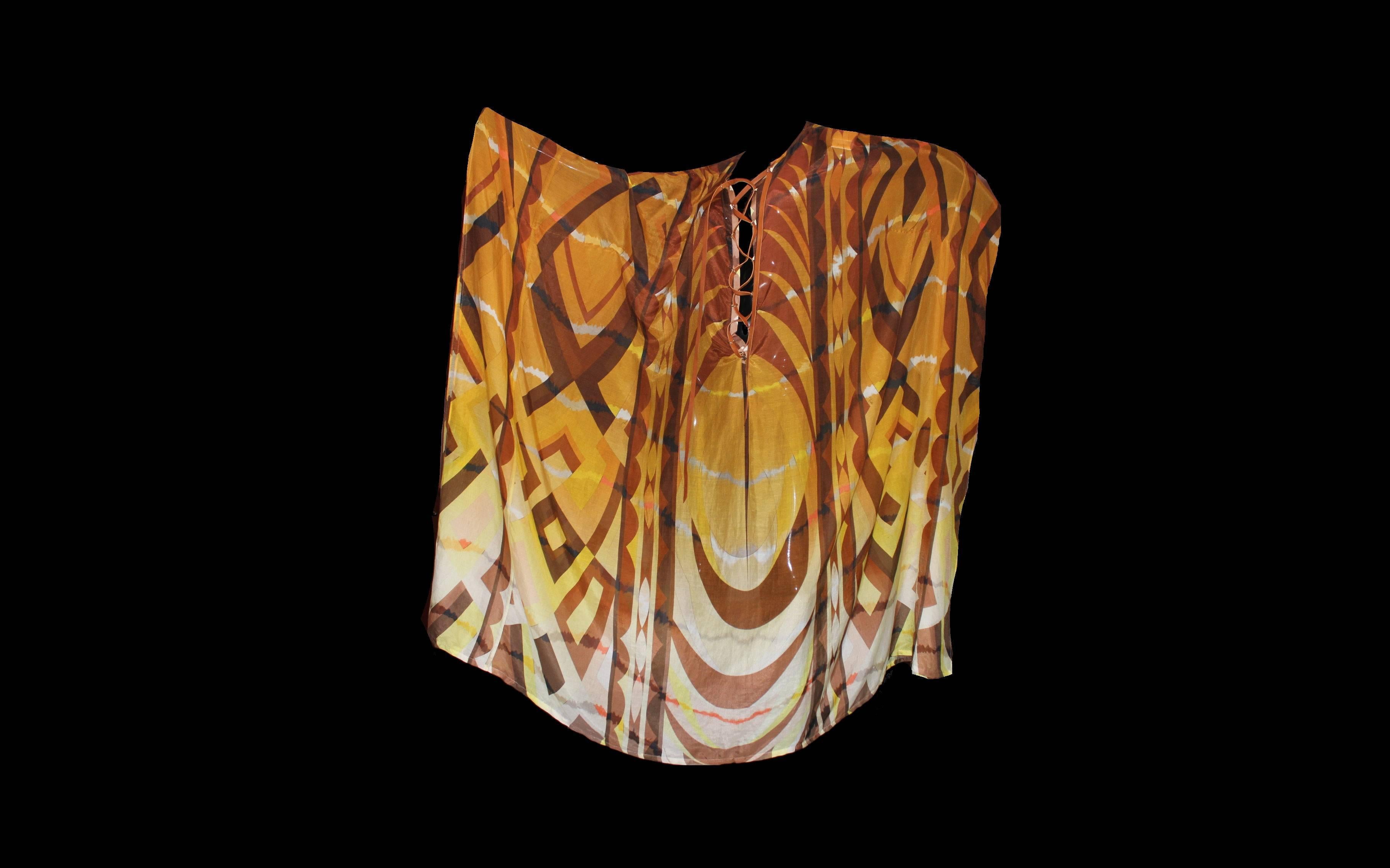 A stunning piece by Emilio Pucci
Maxi kaftan dress
Made of finest silk & cotton voile fabric
Signature print signed with "Emilio" all over
Leather lace up detail
Batwing sleeves
Made in Italy
