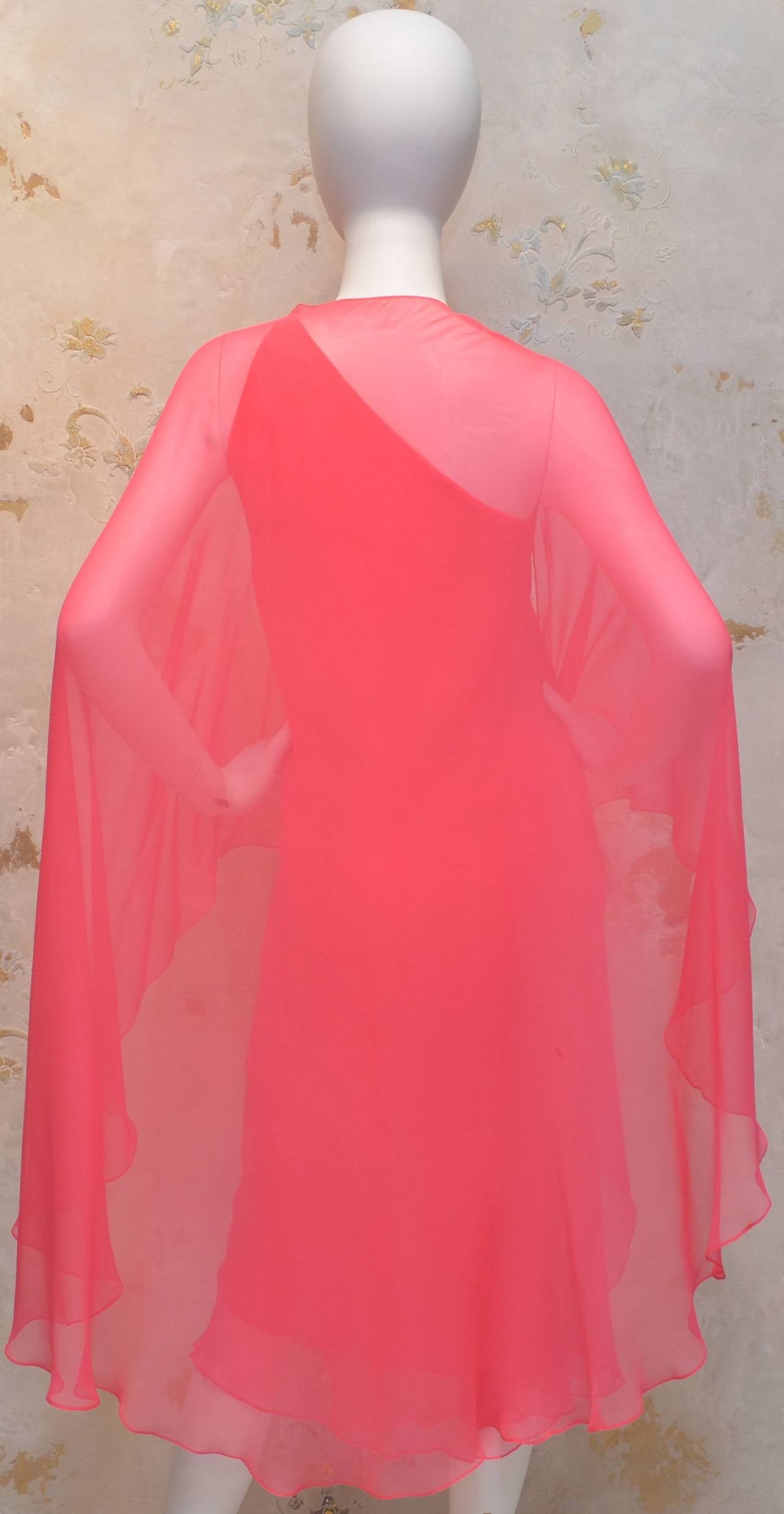 Features a hook-and-eye closure at one shoulder, opposite shoulder is covered and also has a hook-and-eye closure. Dress is in great vintage condition! Label is missing. Dress fits the mannequin perfectly giving the measurements of:

Bust -