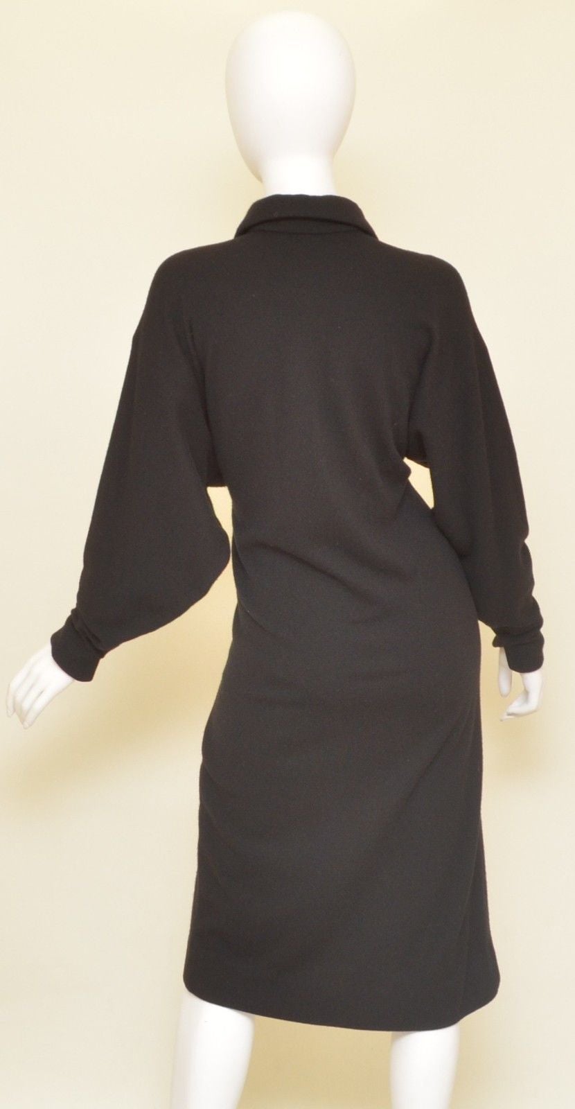 Halston cashmere dress has three button closures along the front and slits at the cuffs. 

Measurements:
Bust - 40''
Waist - 37.5''
Hips - 37.5''
Sleeve Length - 22''
Length - 44.5''