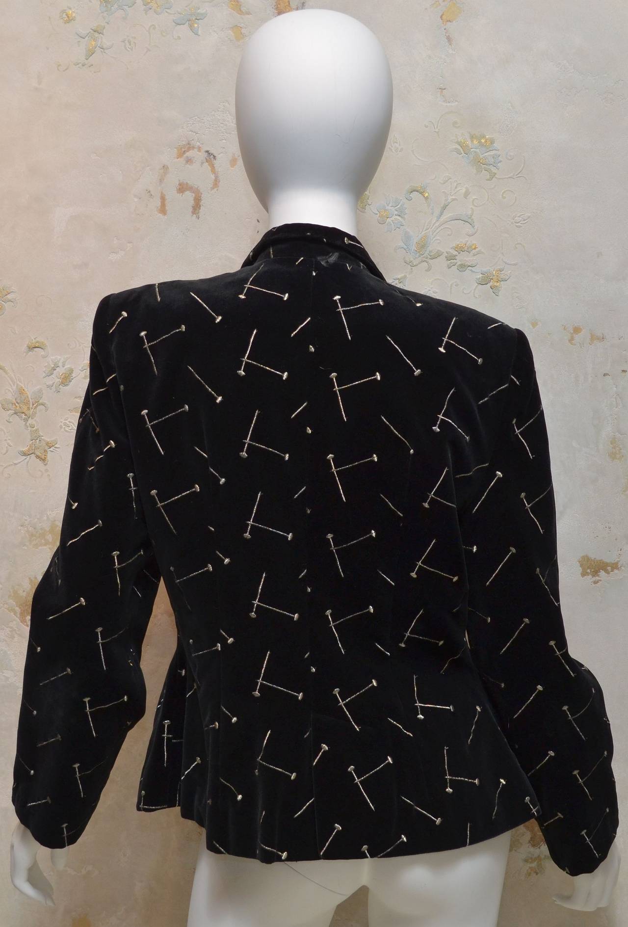 Patrick Kelly black velvet blazer embroidered with a flat head nail pattern in gold thread. Nail shaped metal buttons at front closure.Blazer is fully lined. Made in France.

Measurements:
Bust - 38''
Sleeves - 24''
Shoulders - 17''
Length -