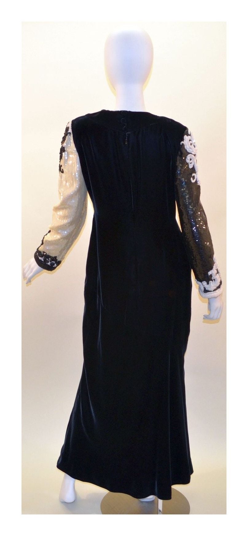 Vintage Bill Blass Gown features back button and zipper closures, full lining, fully beaded and sequined rococo sleeves. Dress is in great condition with normal wears throughout. Left sleeve has a small hole by the pit area but is an easy repair. No