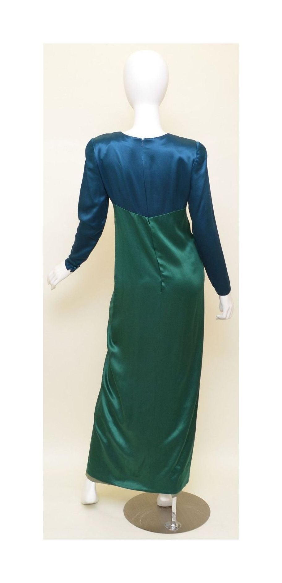 Sophisticated Bill Blass satin long dress features a back zipper fastening, button closures along the cuffs, olive/taupe under layer, and padded shoulders. Dress is in excellent condition overall with minimal wears.

Measurements:
Bust -