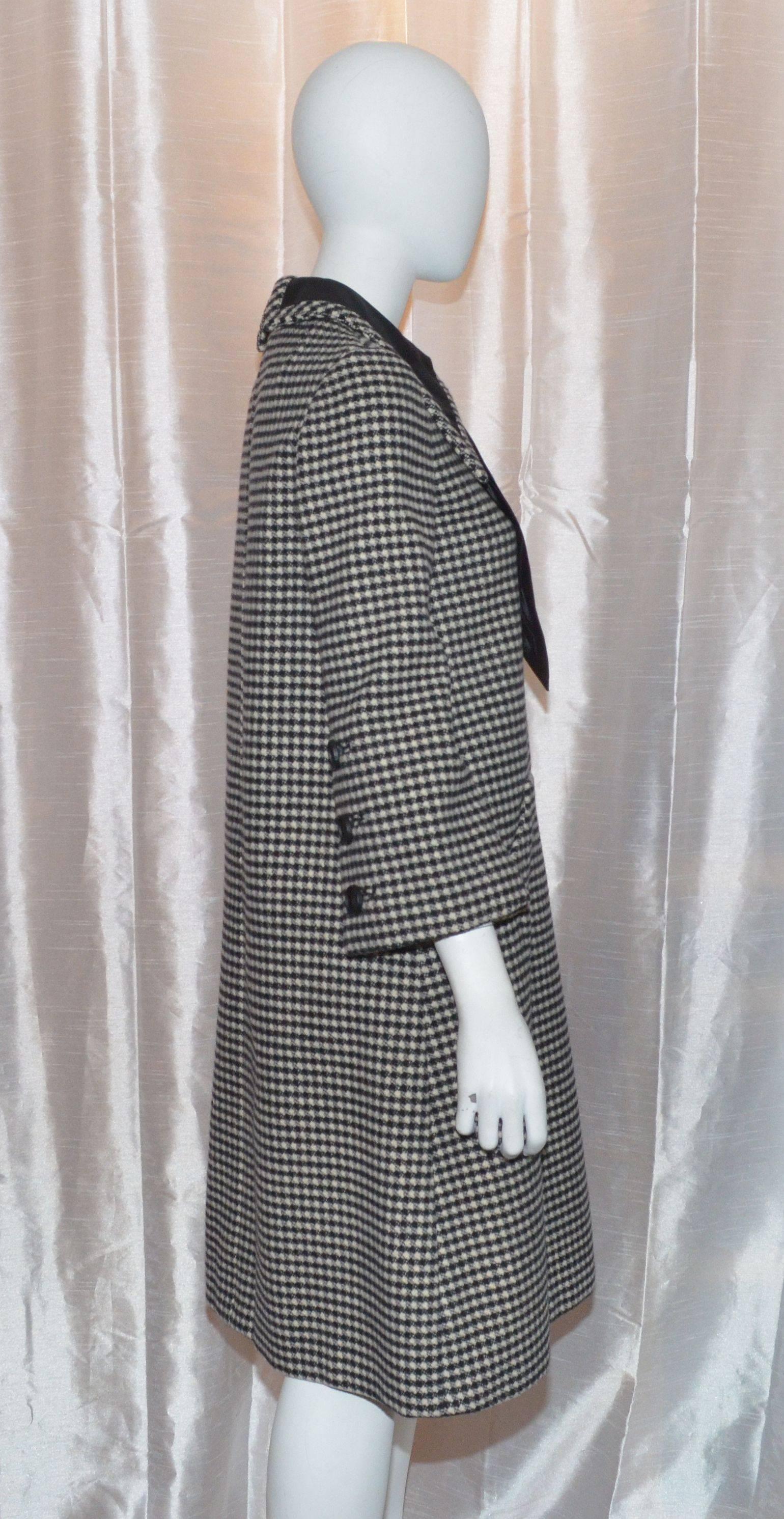 Vintage Geoffrey Beene 1960s Houndstooth Knit Large Collar and Bow Coat Dress
Vintage dress features large collars, and a satin bow that has a hook-and-eye closure at back. Dress also has a back zipper fastening, two slip pockets at the low waist,