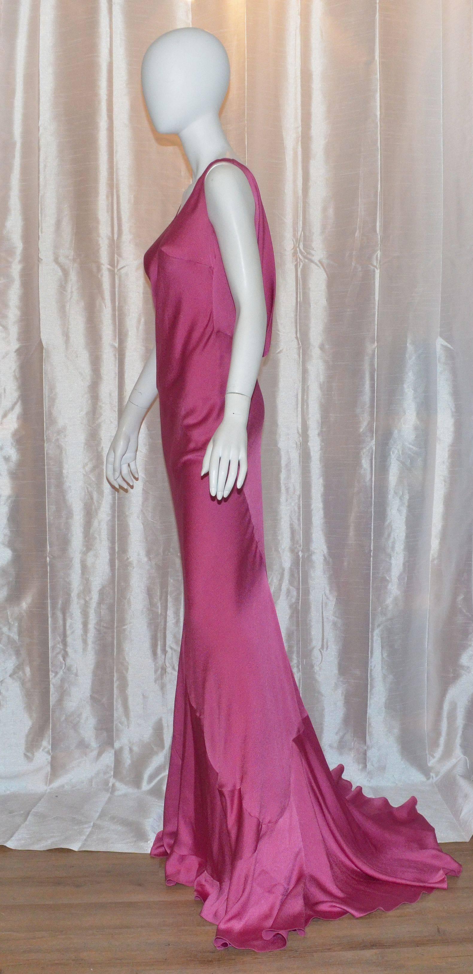 John Galliano Circa 1996 Vintage Bias Cut Hammered Silk Dress Gown with a draped back and scallop seam details.
John Galliano gown is bias cut featured in a fuchsia-colored hammered silk fabric, v-neckline, and a draped open back. Gown was worn