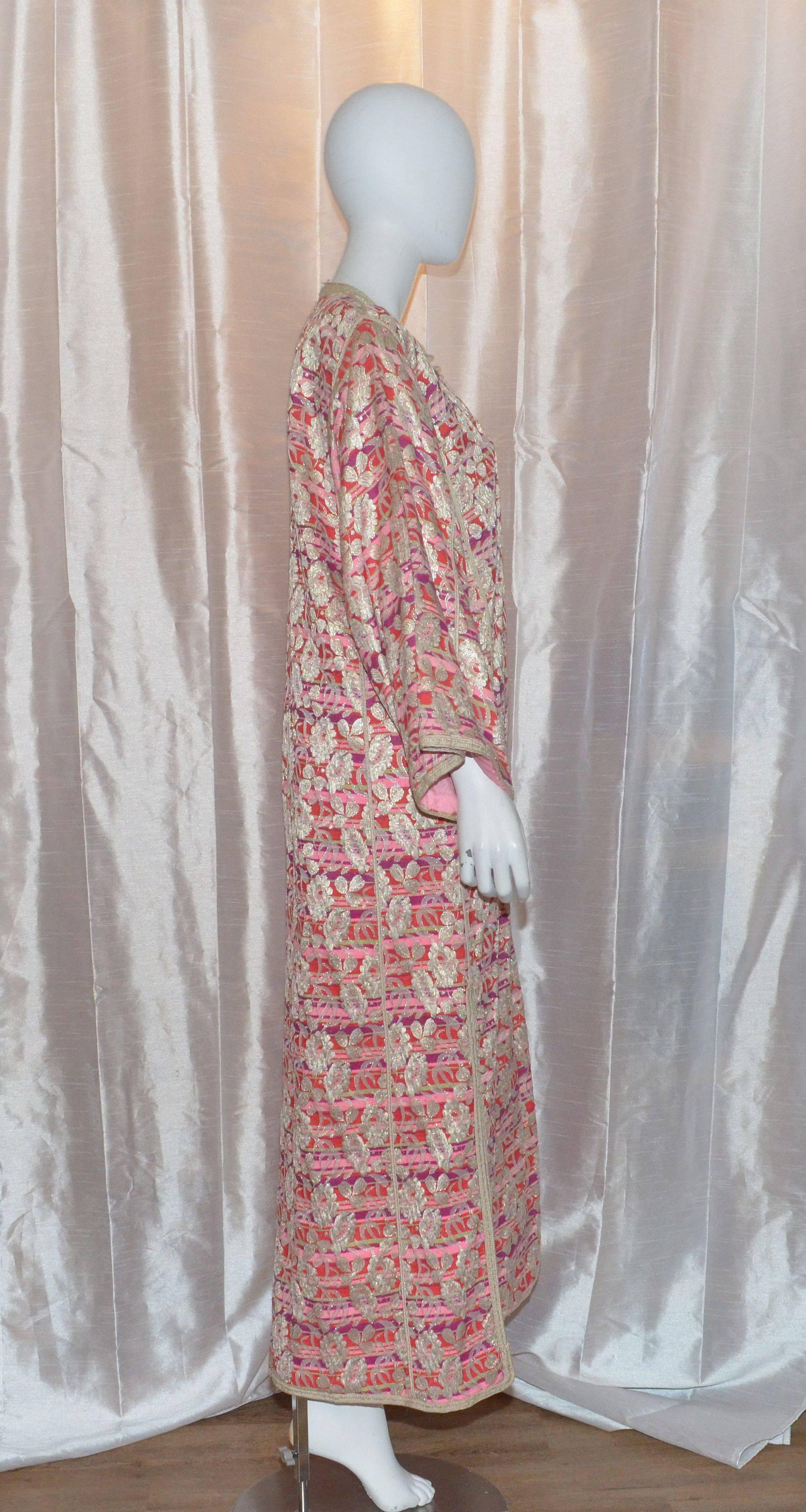 Vintage caftan in a fuchsia and purple striped pattern with metallic thread and floral brocade throughout. Optional button closures along the front and a zipper fastening. Caftan is fully lined in pale pink silk. 

Measurements:
Bust -