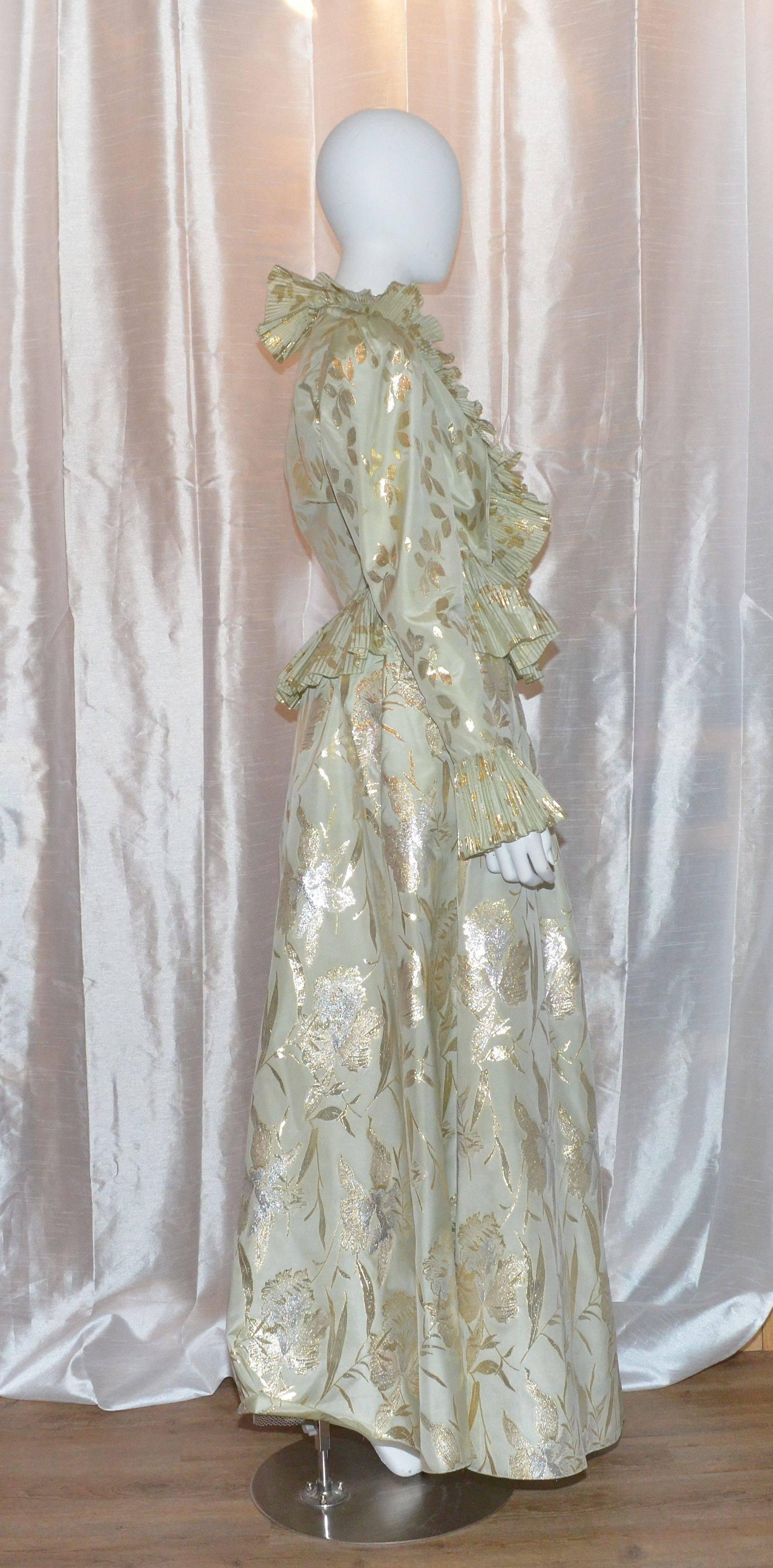 Oscar de la Renta Lame Vintage Taffeta Ball Skirt & Pleated Jacket 

High Drama from Oscar de la Renta in a featherweight silk brocade.  Skirt set is featured in a soft green shade with a subtle gold lame floral pattern throughout. Blouse has a