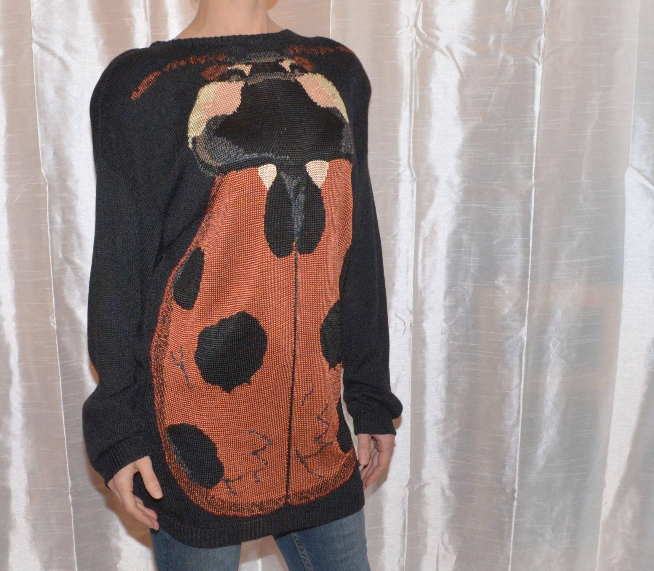 Krizia vintage sweater in a knitted rayon fabric with a large ladybug on the front. Sweater is labeled a size 42 and is made in Italy.

Measurements:
Bust - 42''
Sleeves - 21.5''
Shoulders - 25''
Waist - 38''
Length - 29''