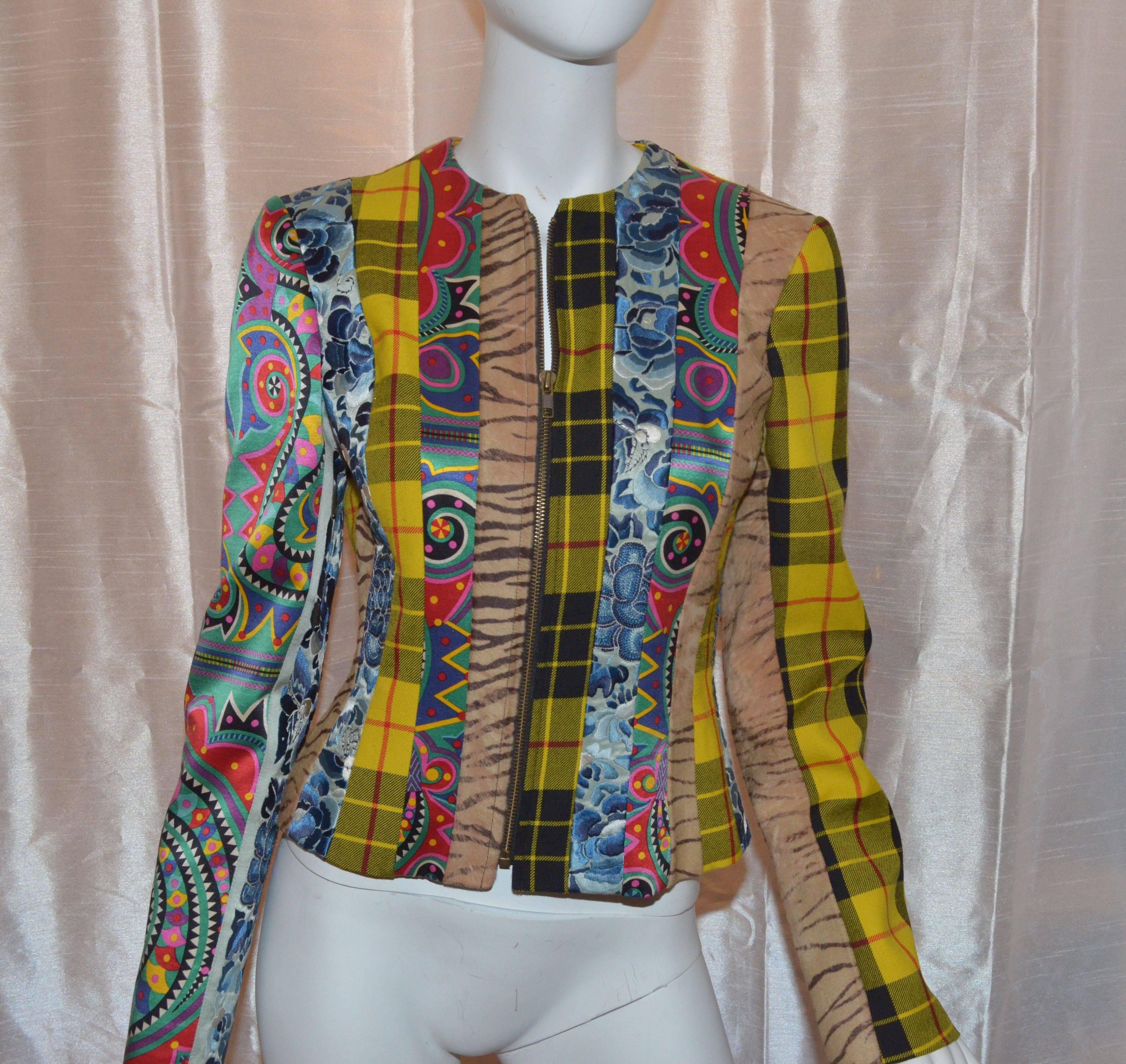 John Galliano jacket has a zipper front closure and is fully lined in 100% silk. Left sleeve of the jacket features a plaid wool and printed calfskin panel; Right sleeve has a multicolored print satin panel and a floral embroidered panel. Made in