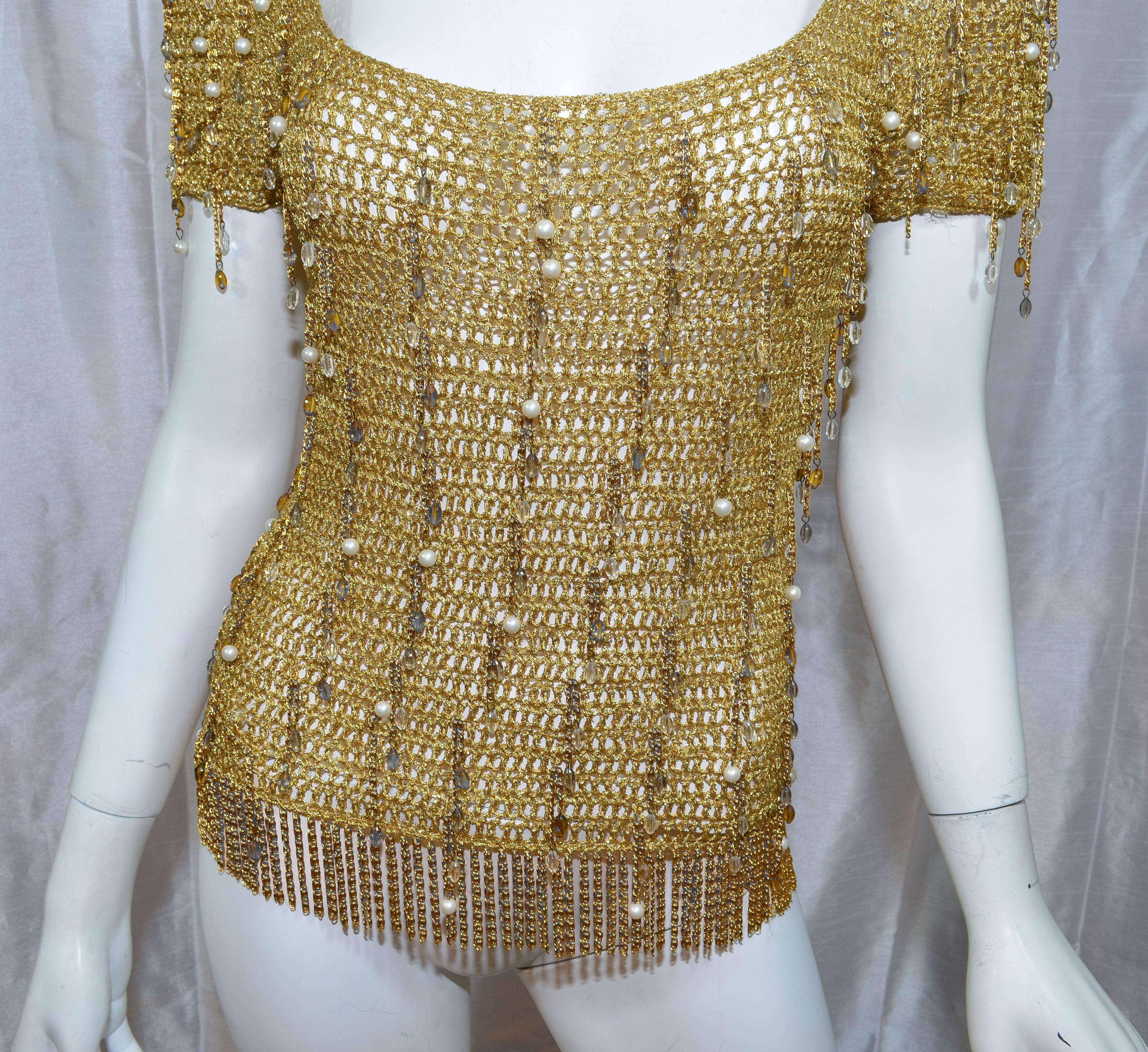 Loris Azzaro 1970s Vintage Gold Knit Bead Fringe Chain Top

Loris Azzaro top featured a gold metallic knit with dangling beads and chains throughout, and a gold fringed chain hem. In excellent vintage condition. Measurements are as
