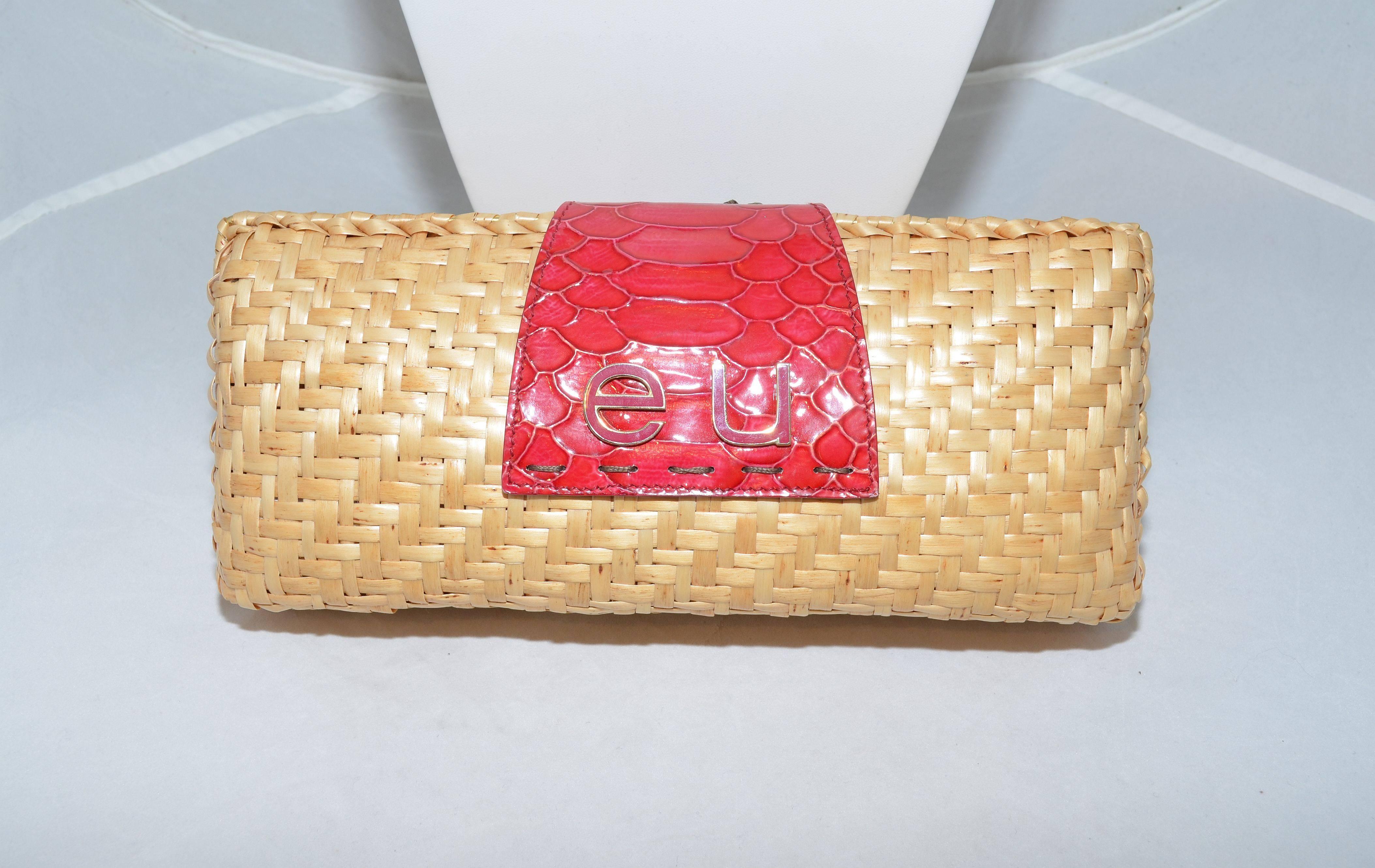 Emanuel Ungaro Woven Wicker Cherry Clutch Purse

Emanuel Ungaro wicker clutch has a patent red pressed leather strap flap closure with cherry fruit detail, concealed magnetic snap stud closure. Clutch has a patent leather and nylon lining with one