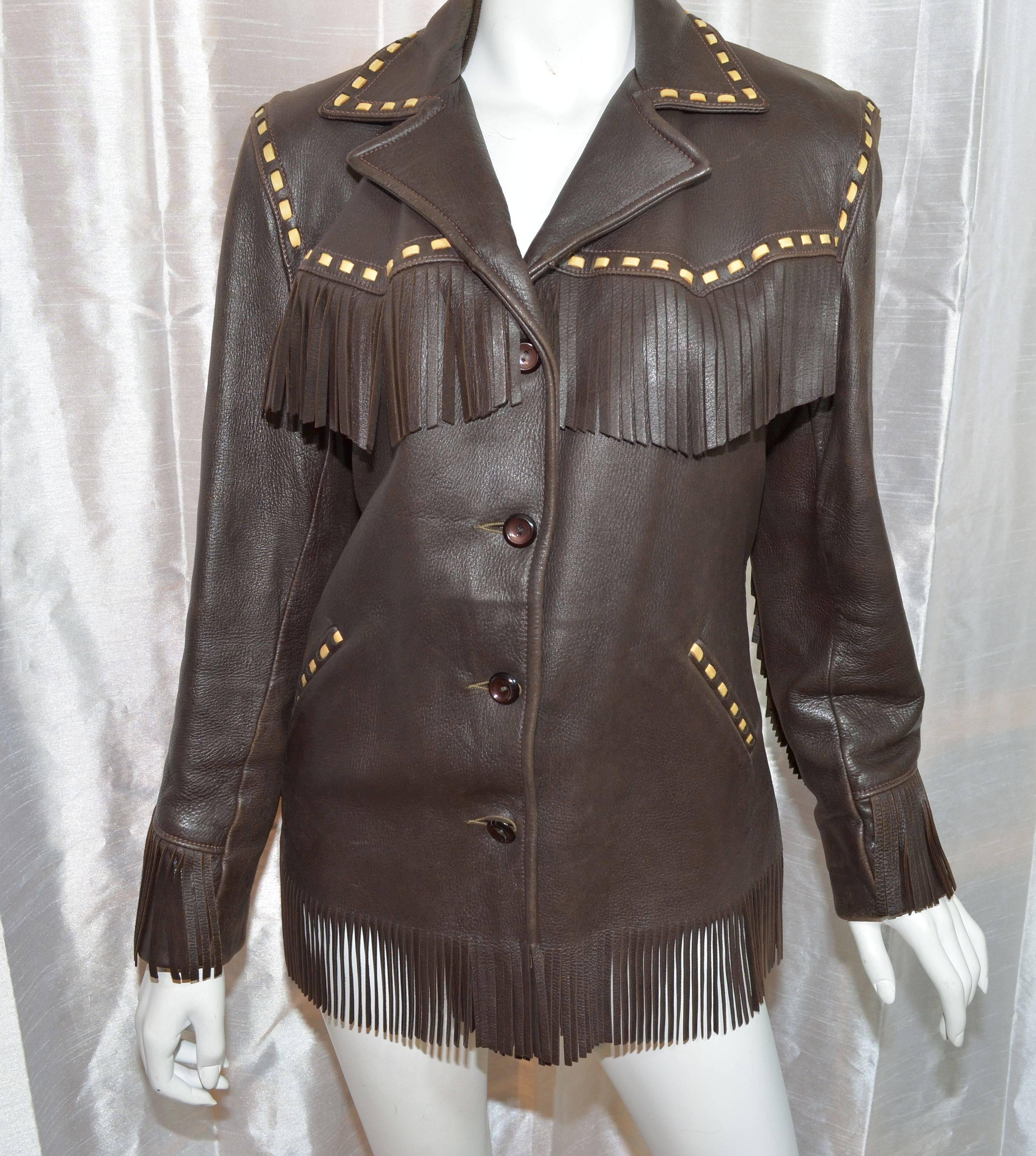 Vintage jacket is made of 100% genuine deerskin leather, featured in a brown color with tan leather trimmings laced along the collar and two front pockets, there are button closures along the front, and a full lining. 
Measurements: 
bust - 42'',