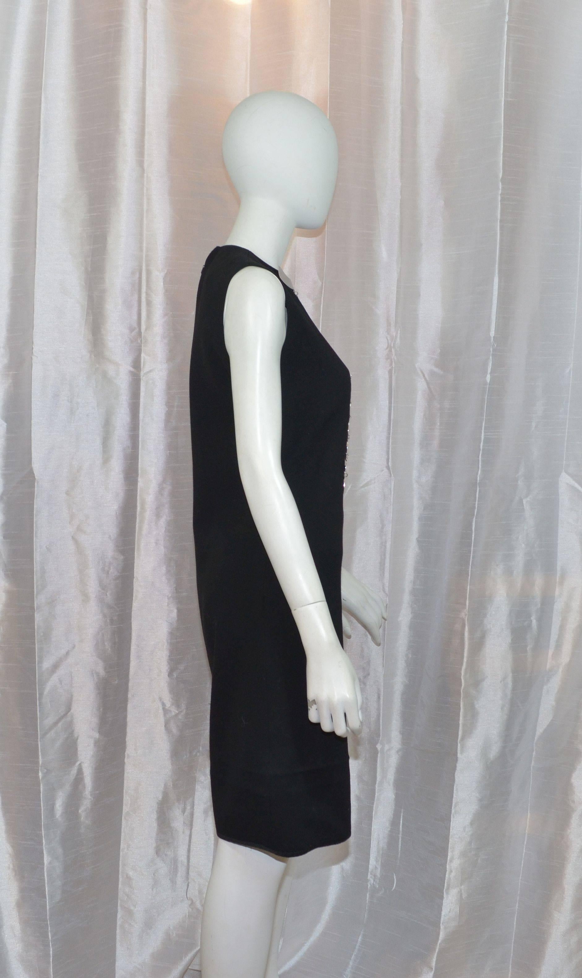 Iconic Pierre Cardin black wool A-line dress with a massive silver metal plate collar. Dress has a back zipper fastening and a is fully lined. Measurements: bust - 36'', waist - 34'', hips - 38'', length - 40'' In excellent vintage condition. This