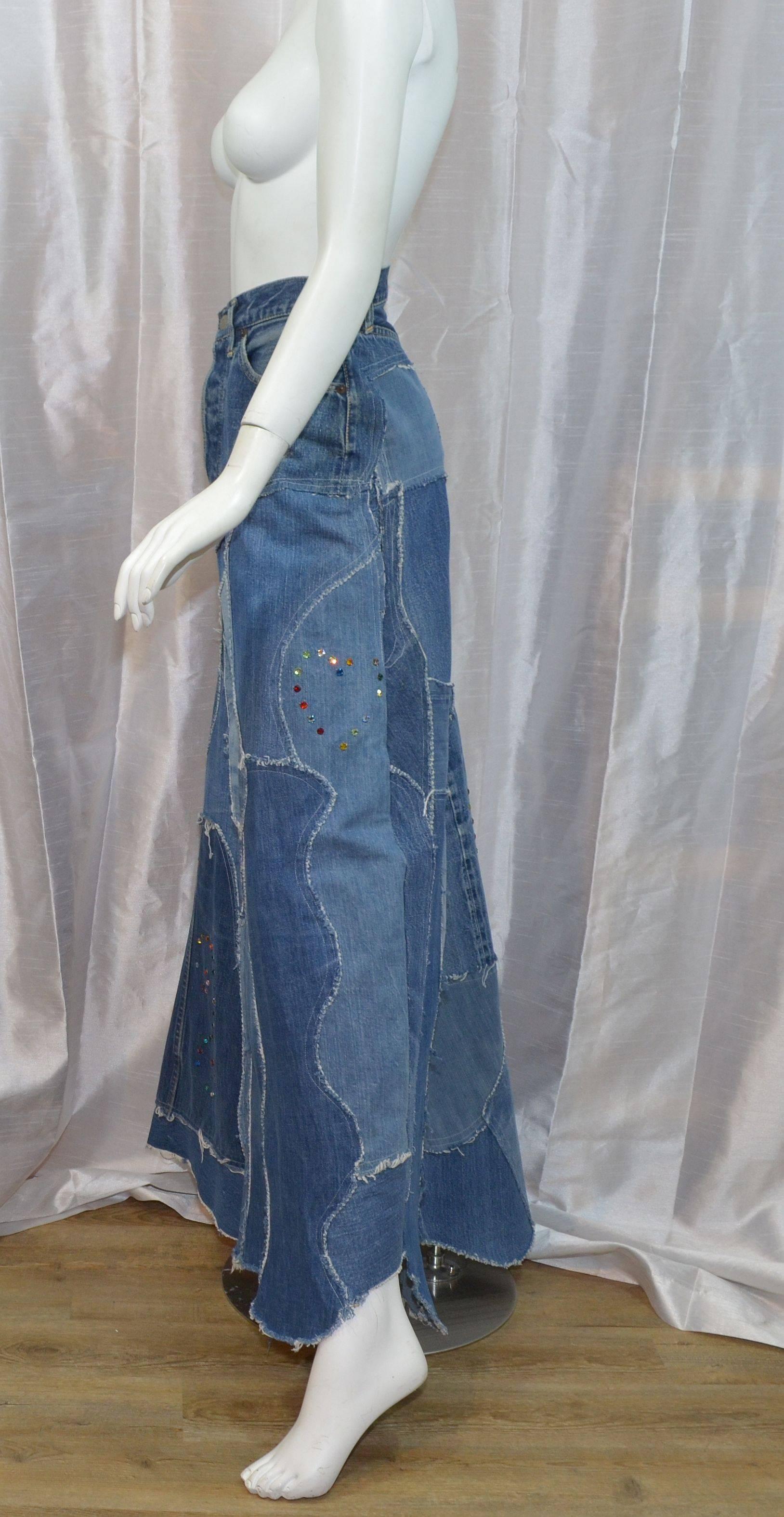 Funk and Flash Custom made original hippie maxi skirt made from Levis Big E denim skirt has five button closures along the front, three pockets at the waist, and multi-colored rhinestone embellishments throughout. Patchwork denim. Measurements: