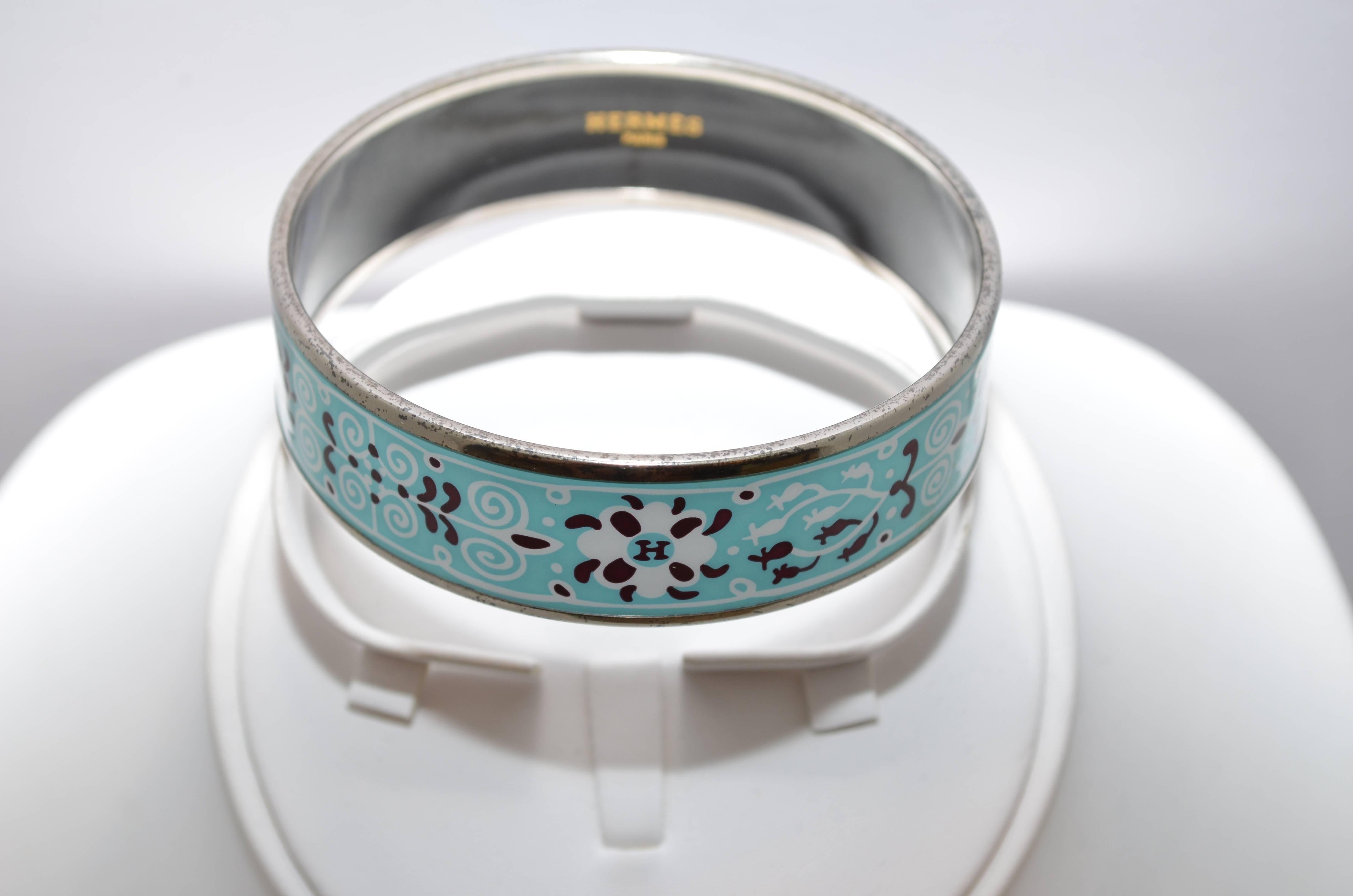 Hermes Paris Turquoise Enamel Print Bangle Bracelet size 70 Large Hermes Paris silver-tone metal bangle features a turquoise background with a print on the enamel, and is made in Austria. Diameter measures 7 centimeters (2.75 inches), width is 2