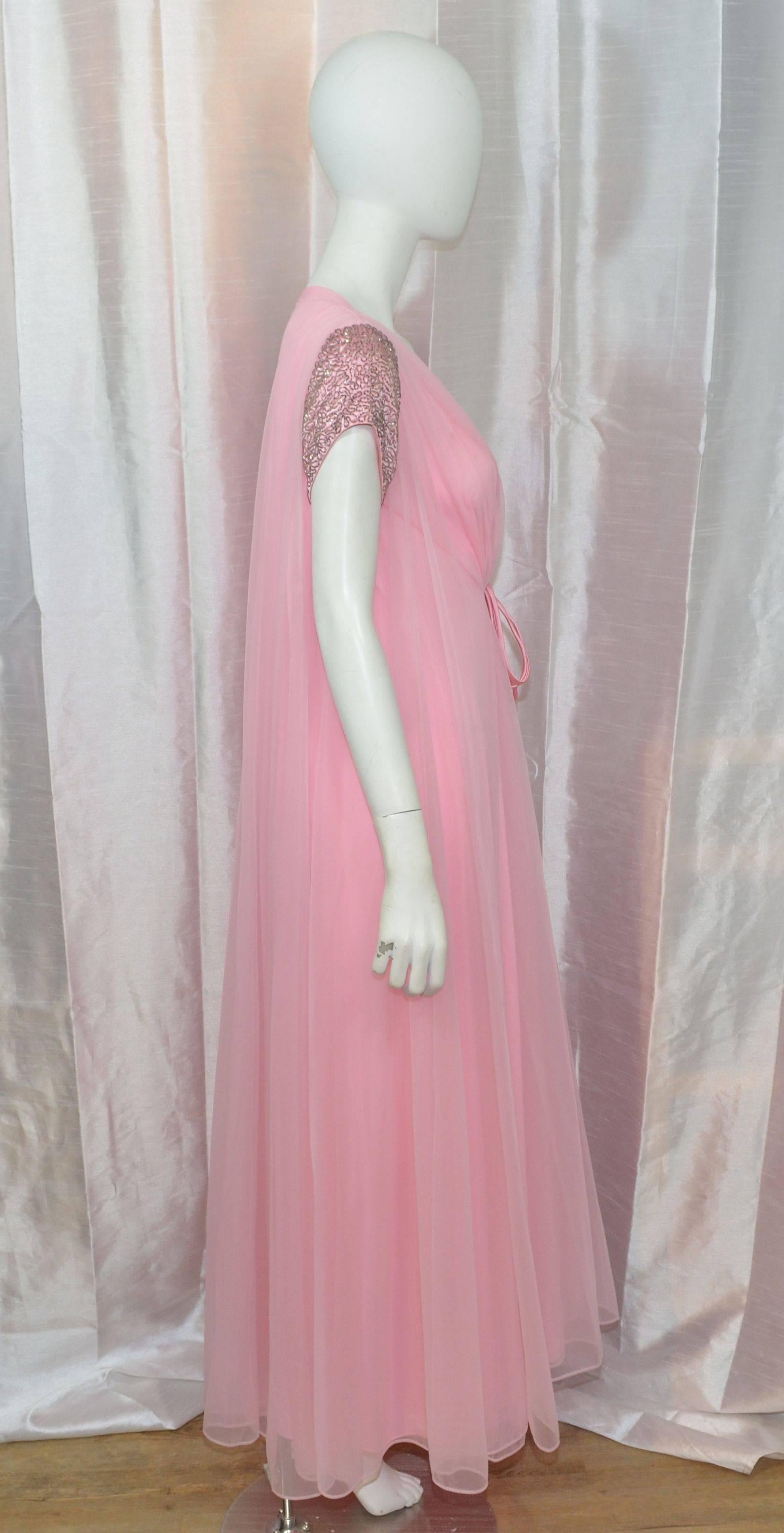 Vintage Confection by Claire Sandra for Lucie Ann from the 1960's. Features lightweight sheer layers of nylon with dual satin string tie closures at the front center with beaded sleeves. Ava Gabor would approve! Fully lined. Size M.

Measurements: