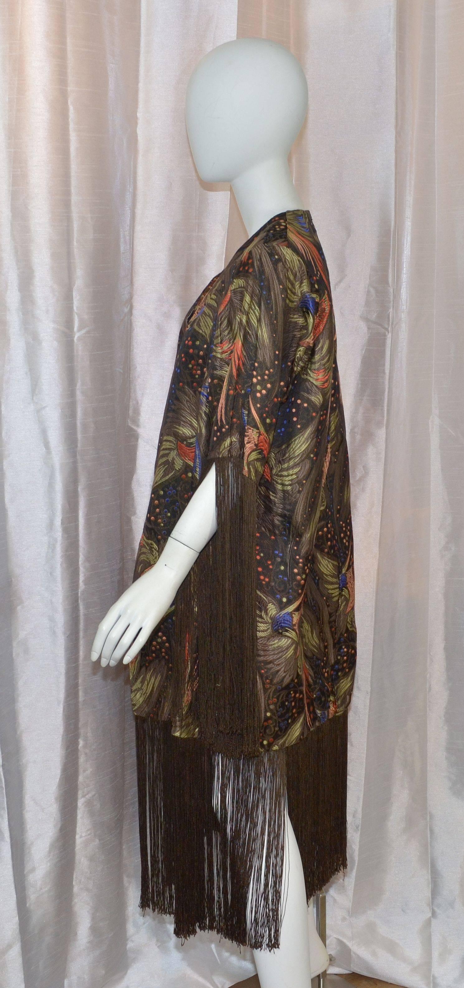 1920s jacket features beautiful multicolored embroidery throughout with fringed trimmings along the sleeves and hem. Jacket has hook-and-eye closures and is fully lined. Very wearable piece.

Measurements are as follows:

Bust - 46''
Sleeves -