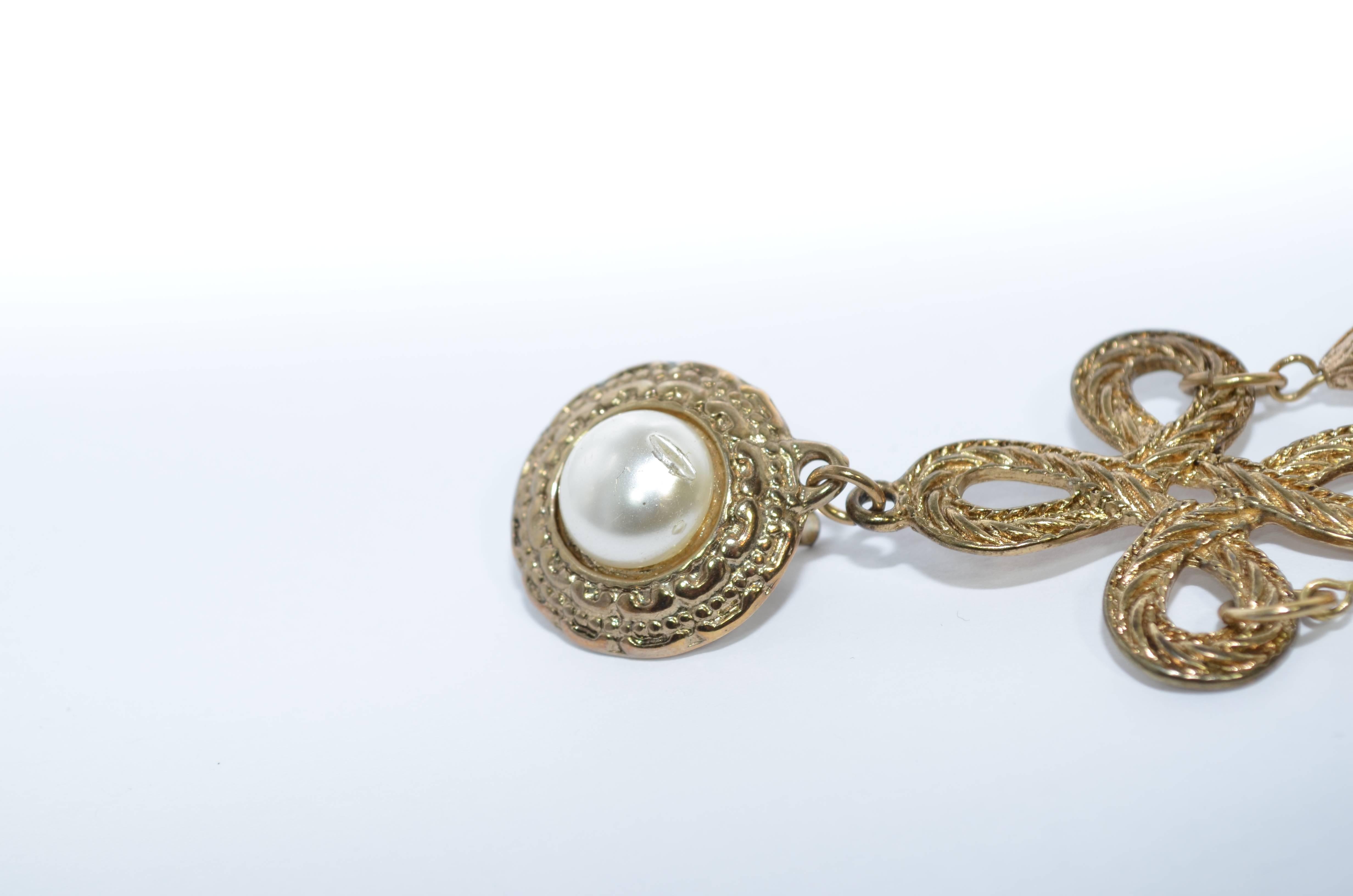 Earrings are featured in an antique gold hardware with 3 dangling pearls and a pearl center stud. Clip on earrings with a baroque style. Length from the clip stud to the longest dangling pearl measures 4.25 inches. One pearl stud has some minor