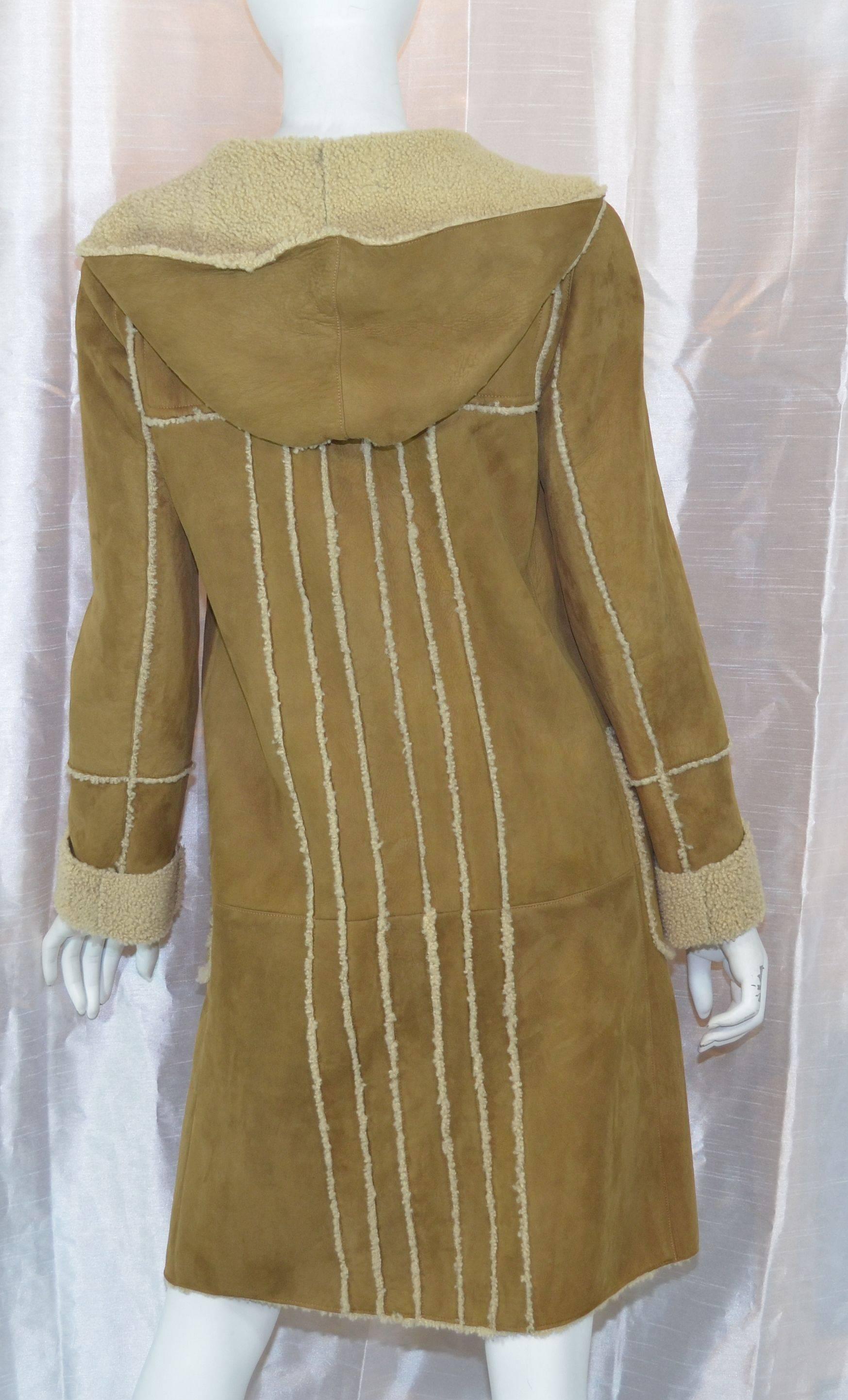 Gorgeous Chanel coat from '06 A collection. Coat is 100% shearling lambswool featured in a light brown color with signed CC logo toggle closures along the front, with two patch pockets at the waist. Labeled a size 36, made in France. Measurements at
