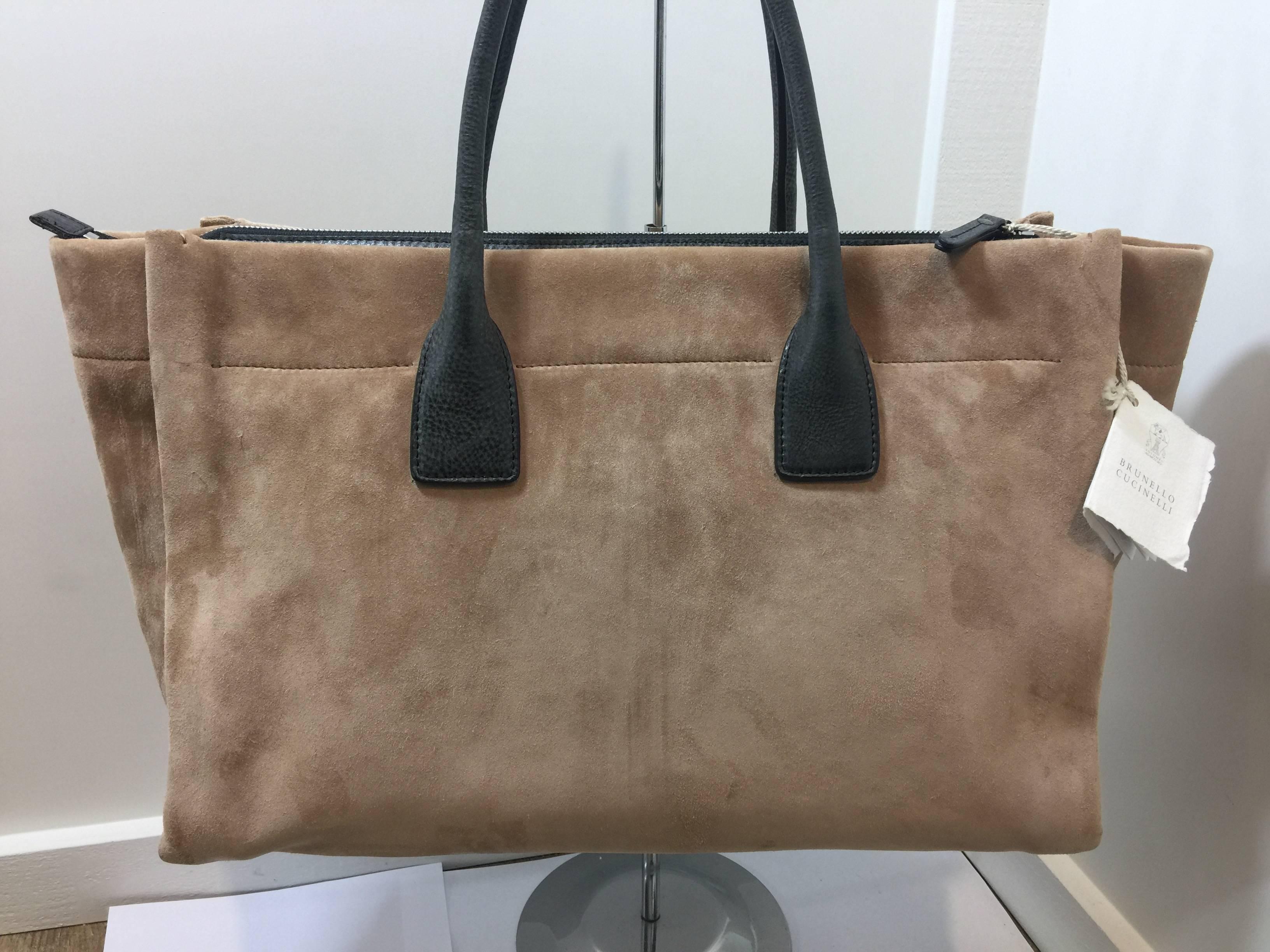 Large Brunello Cucinelli Butter Soft Suede and Leather Tote

Dark grayish brown textured leather tote handles, bottom panel and interior. Zipper top for security. One inside pocket with zipper and 2 open inside pockets. Metal feet at bottom. Very
