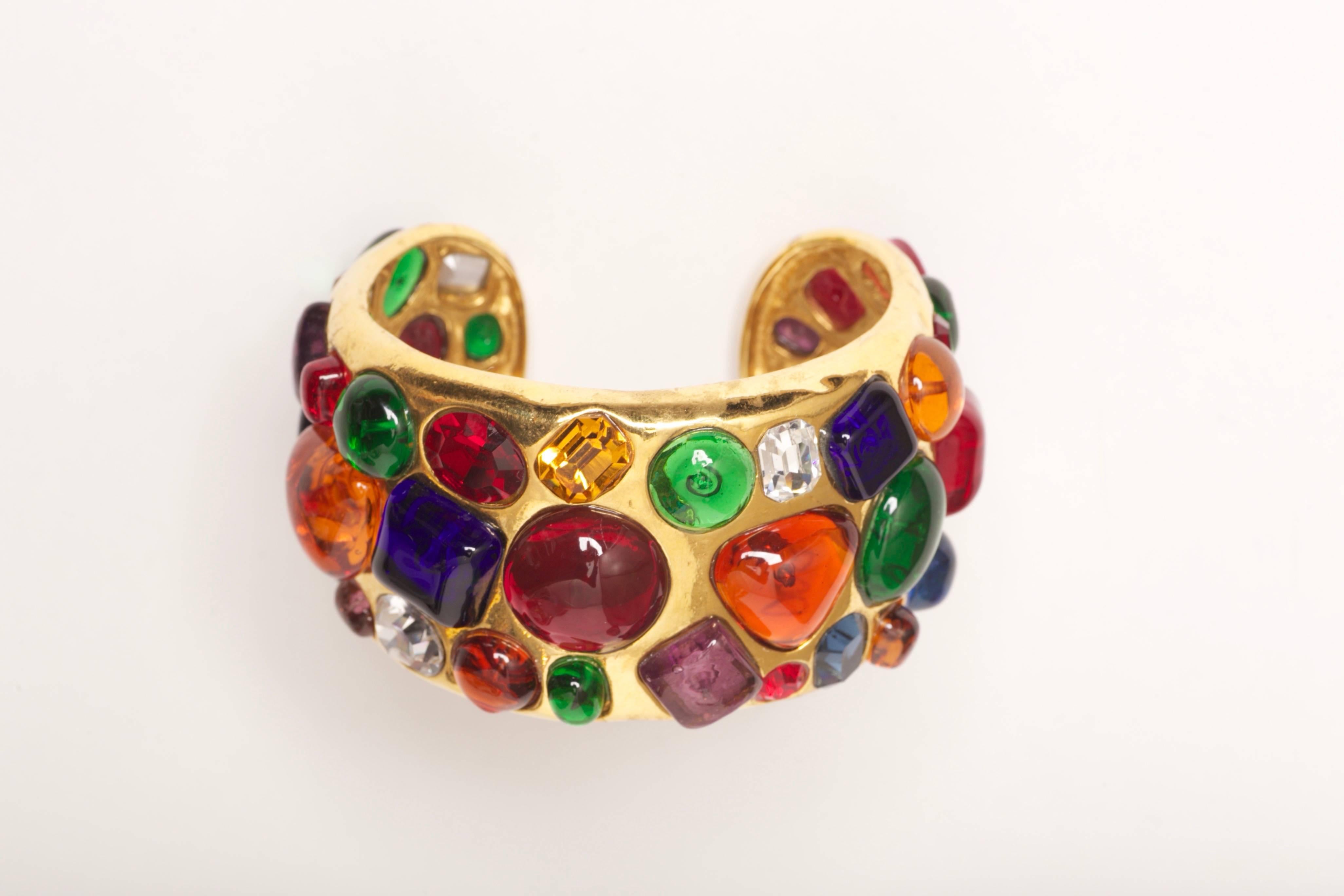 Substantial Chanel Gripoix Cuff Bracelet Collection 26 from 1988

Heavily embellished Chanel cuff with open back high relief Gripoix poured glass in varied colors and shapes and open back emerald cut crystals in sapphire, topaz and diamond colors.