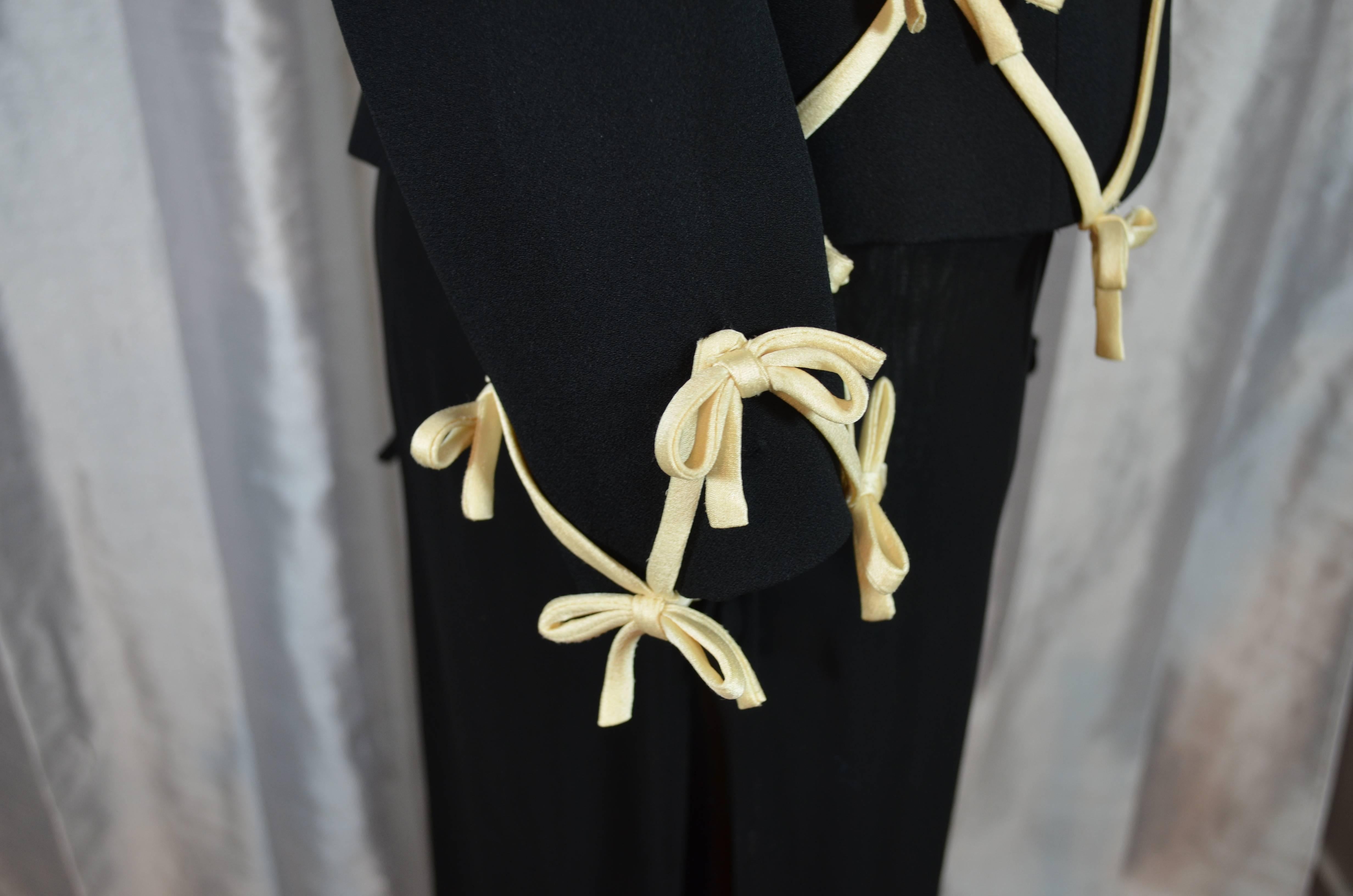 Moschino Cheap and Chic 3 Piece Bow Embellished Pants Suit

Jacket:
Black crepe open front jacket with cream satin lattice bow embellishments on the front and at the sleeve cuffs. Fully lined. Labeled a US size 6. Excellent condition. Fabric 79%