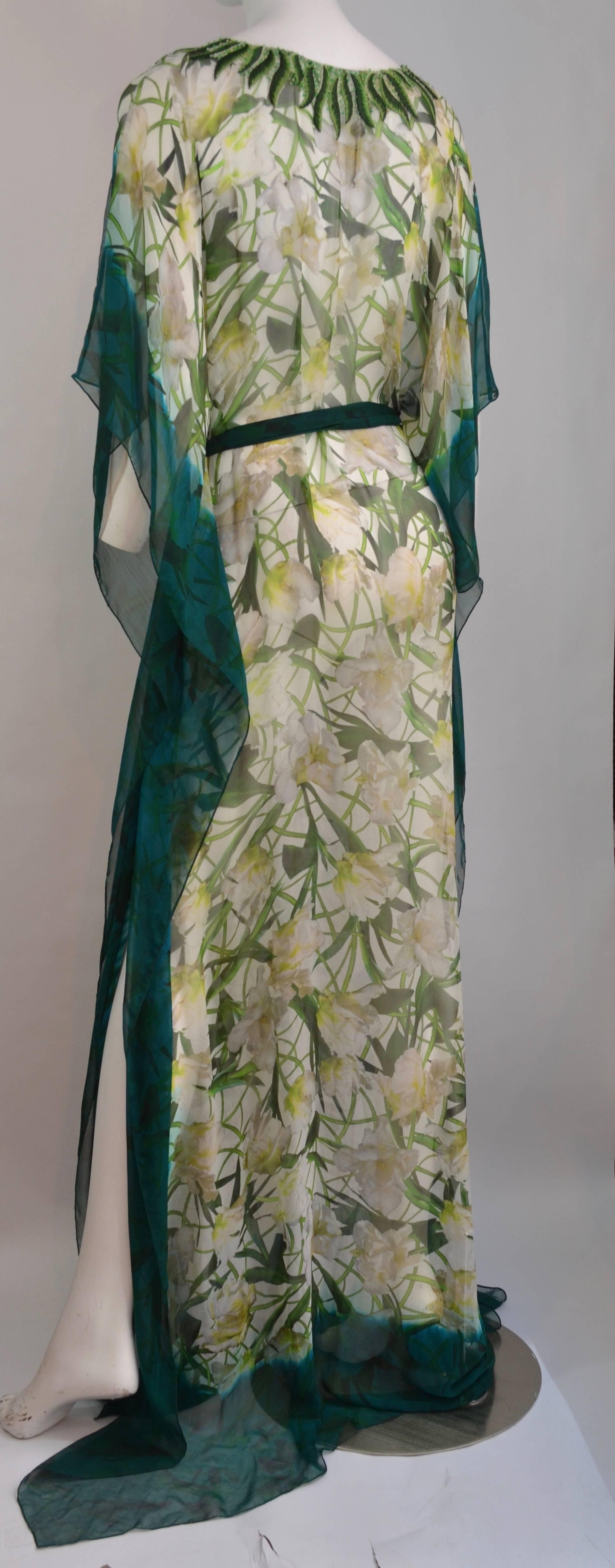 Oscar de la Renta bias cut sheer silk chiffon caftan / Kaftan with white freesia floral print and jade blue-green borders.  The neckline is embroidered with leaves and accented with seed beads.  The waistline has a matching silk chiffon belt that is