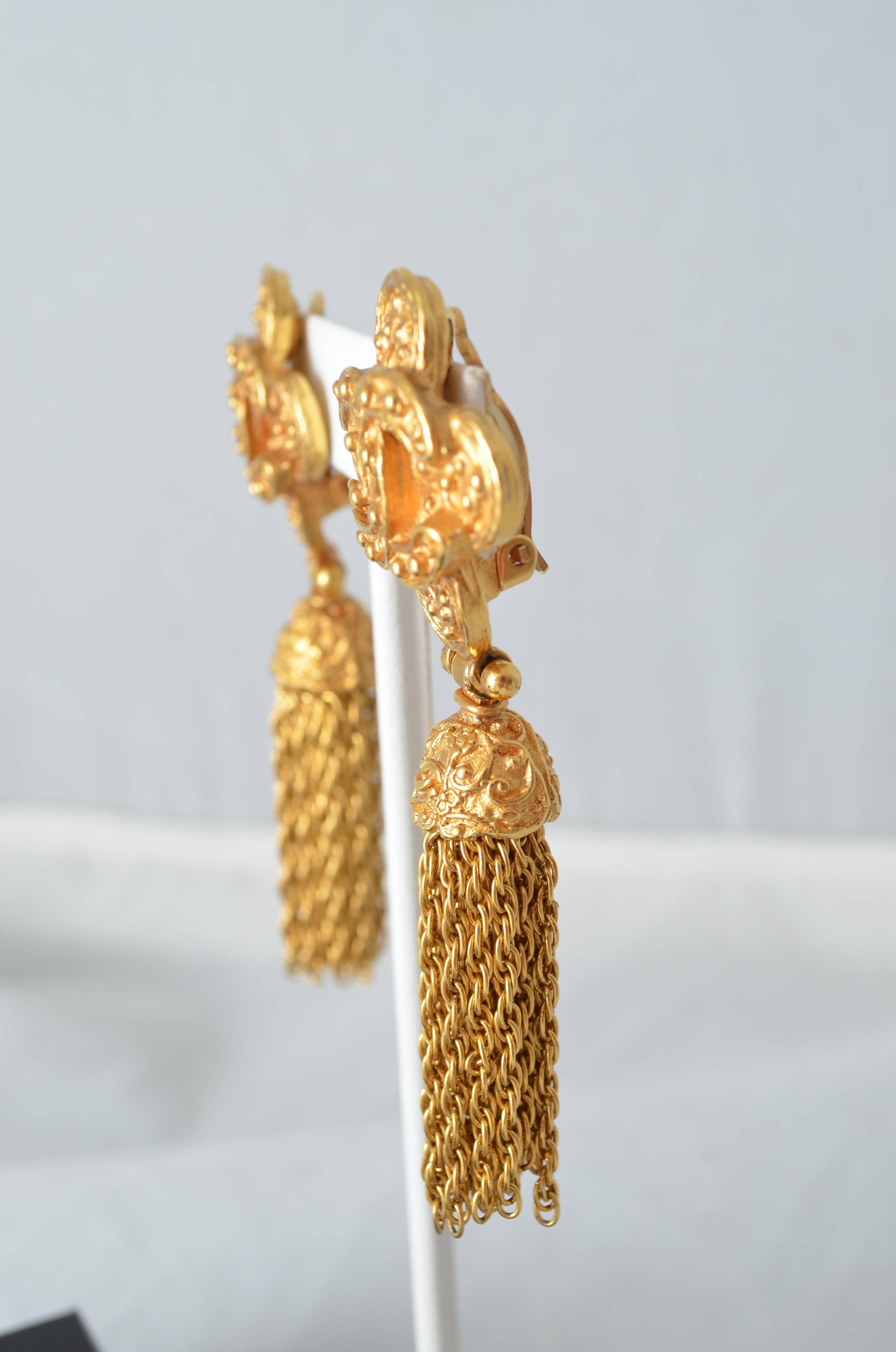 Chanel gold tone metal drop/chandelier clip earrings with gold chain fringe tassel in box. Logo on inside of back of earring stamped Chanel, 94A, Made in France . Bottom half of earring hinges with attached chain fringe rope detail. Excellent