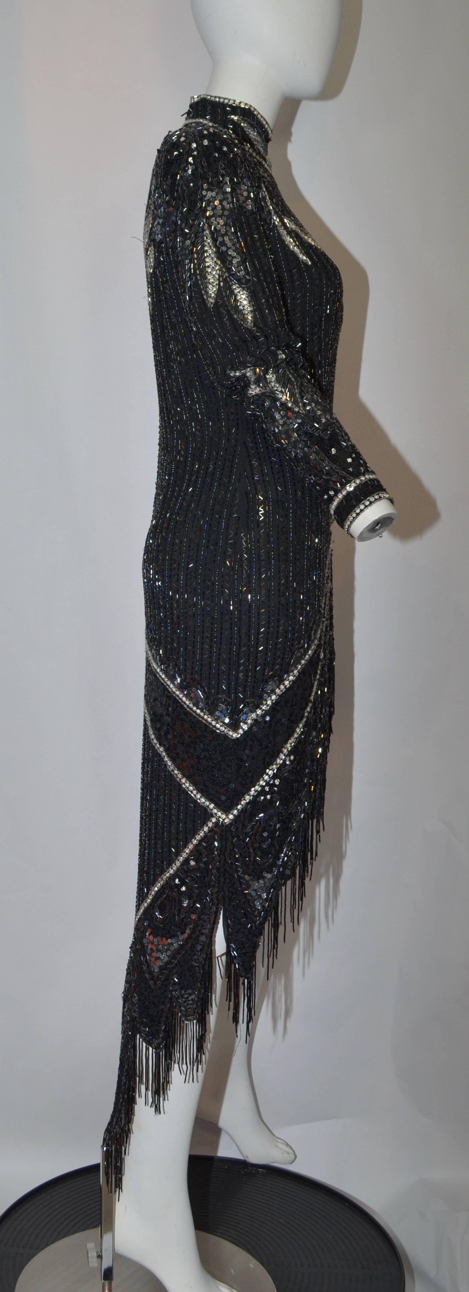 Exquisite Bob Mackie 1980's Silver and Black fringe beaded dress with hi-lo hem and 3 inch fringe on the lower hem and wrap portion of the front skirt of the dress. Lots of movement in the front due the the wrap skirt with layers of fringe. Silver