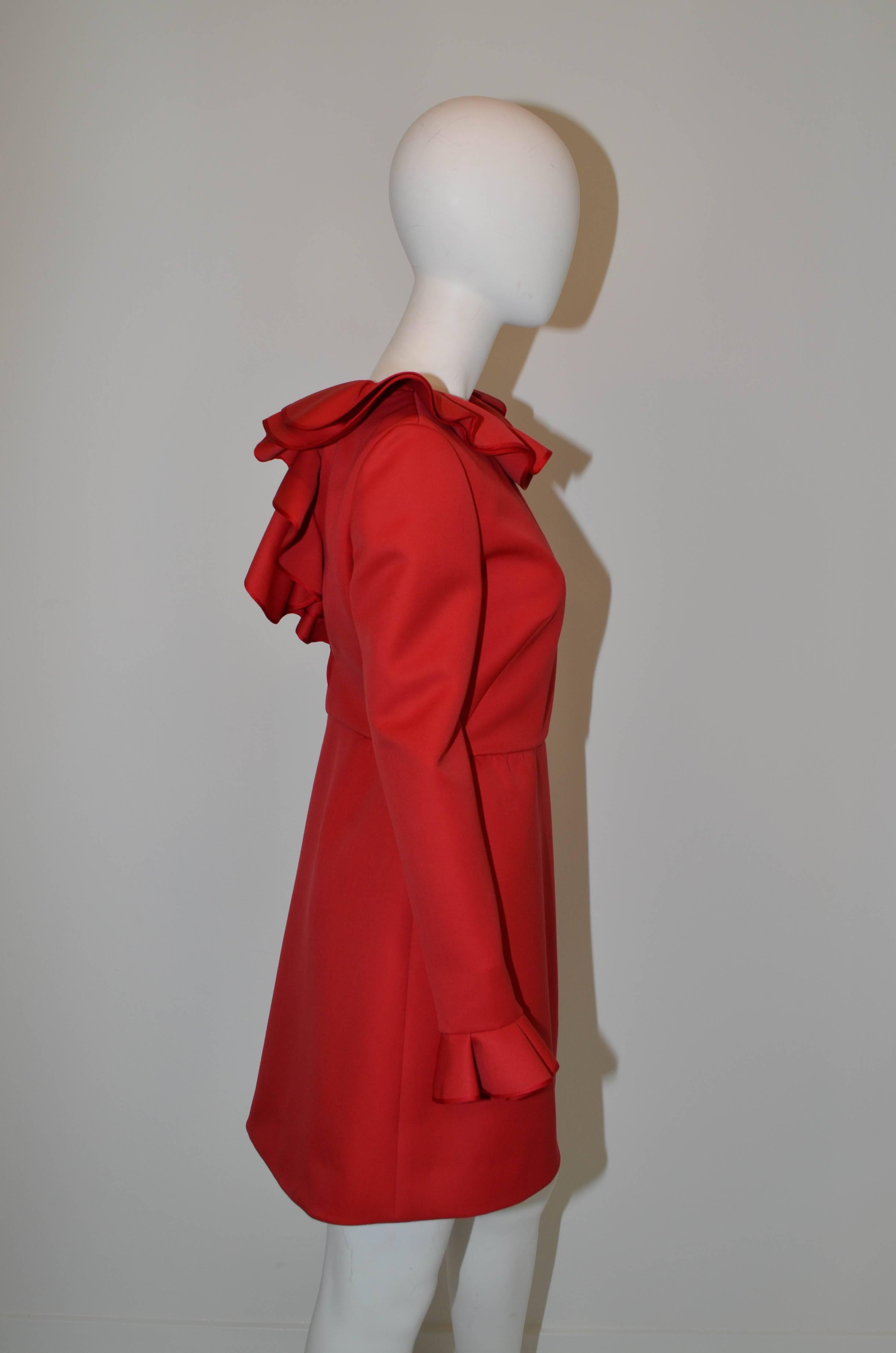 Beautiful structured wool Valentino ruffle dress in classic signature red, featuring a ruffled neckline and sleeve. This dress is from recent collection and is in excellent condition. Made in Italy. Marked size 8.
Measurements: 
Bust 34
Waist