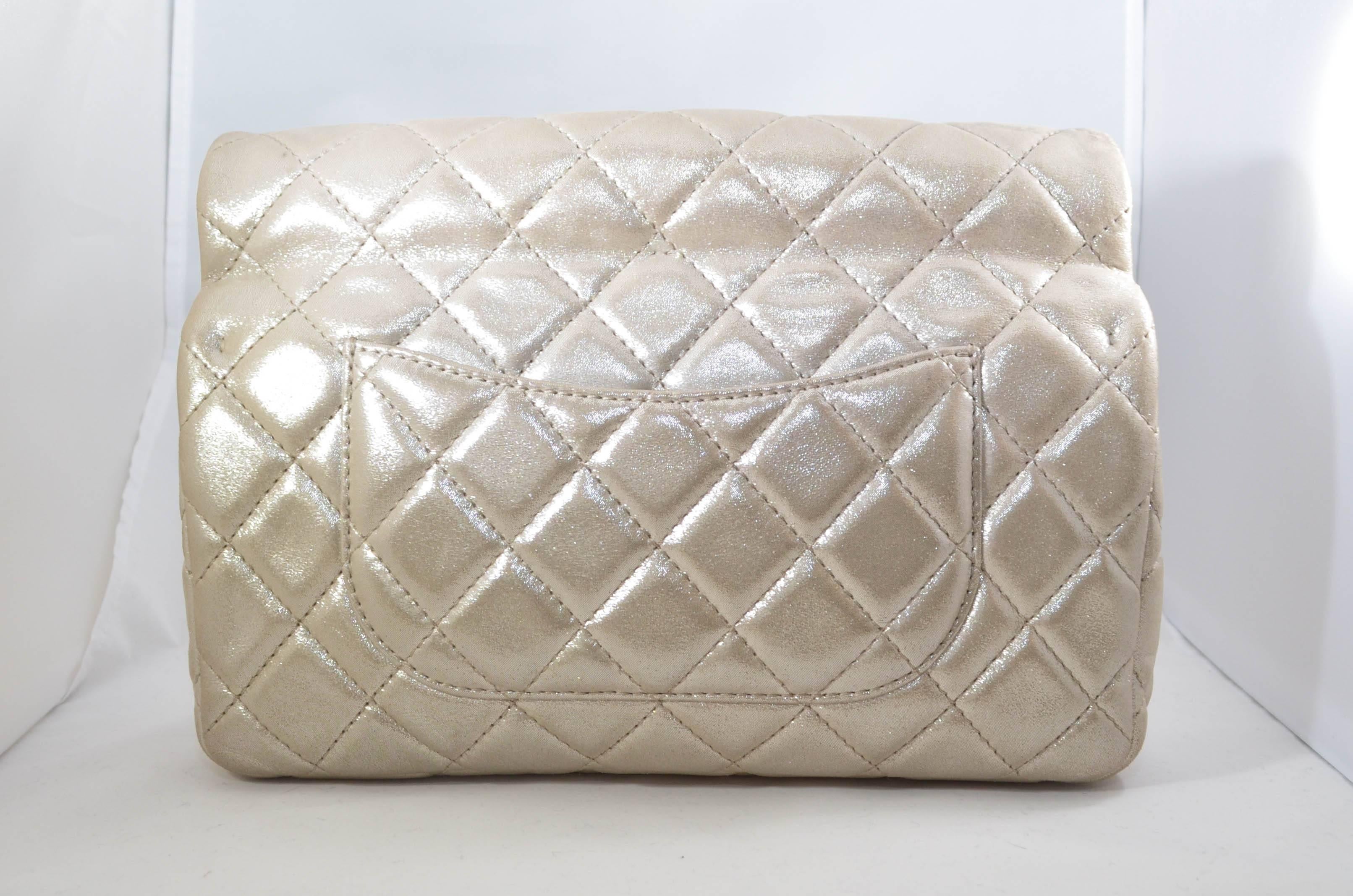 This fabulous Chanel Reissue Roll Top Clutch Quilted Lambskin is ideal for nights out. Crafted in quilted lambskin leather, this clutch features rolled top handle, frontal flap, exterior back pocket and hardware accents. Its mademoiselle turn-lock